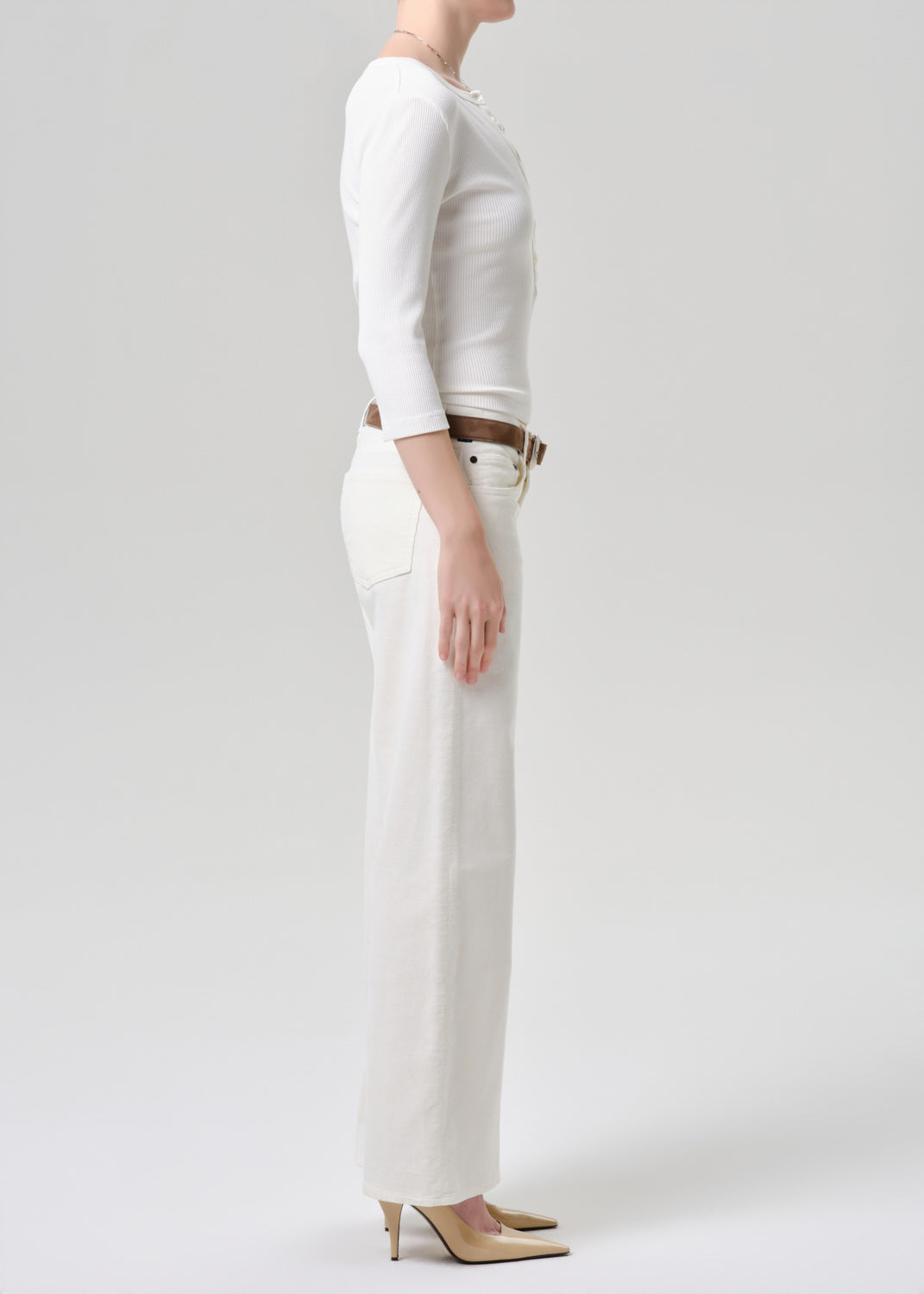 Person wearing a white outfit with a plain background