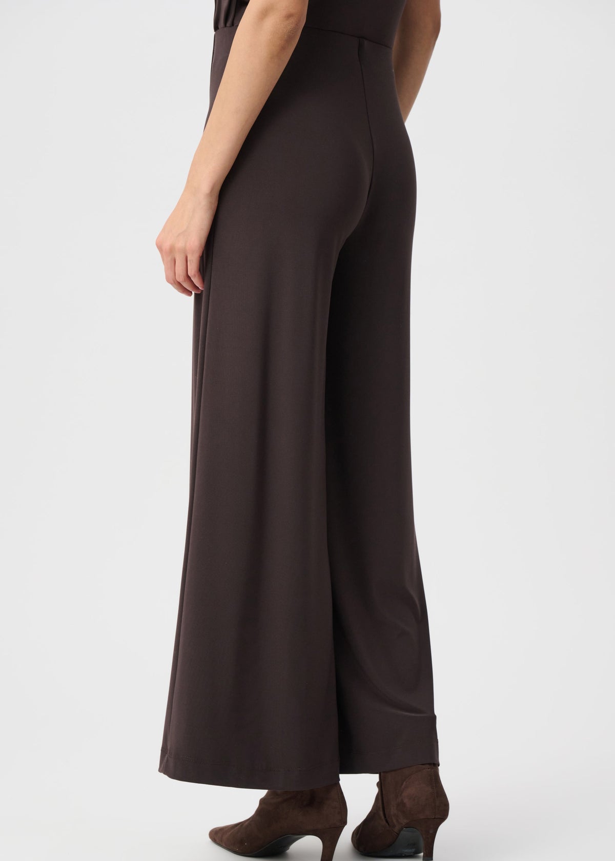 Brown jumpsuit worn by a person on a white background