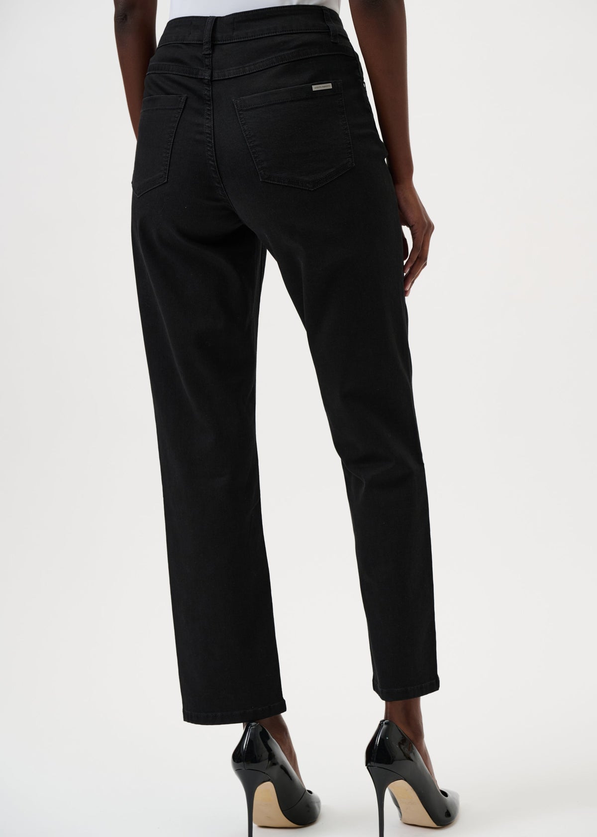 Black pants worn by a person on a white background