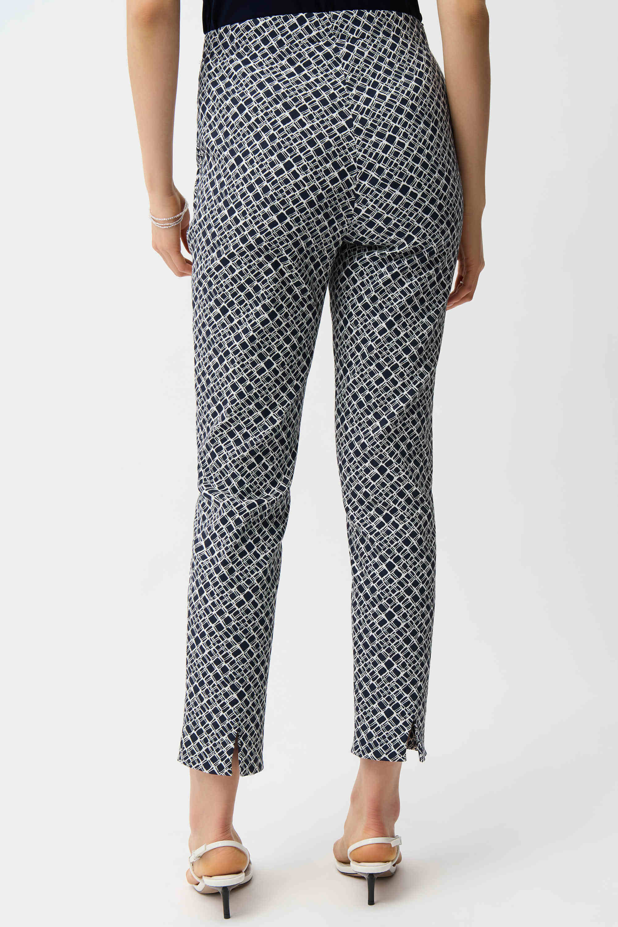 Person wearing patterned pants on a white background