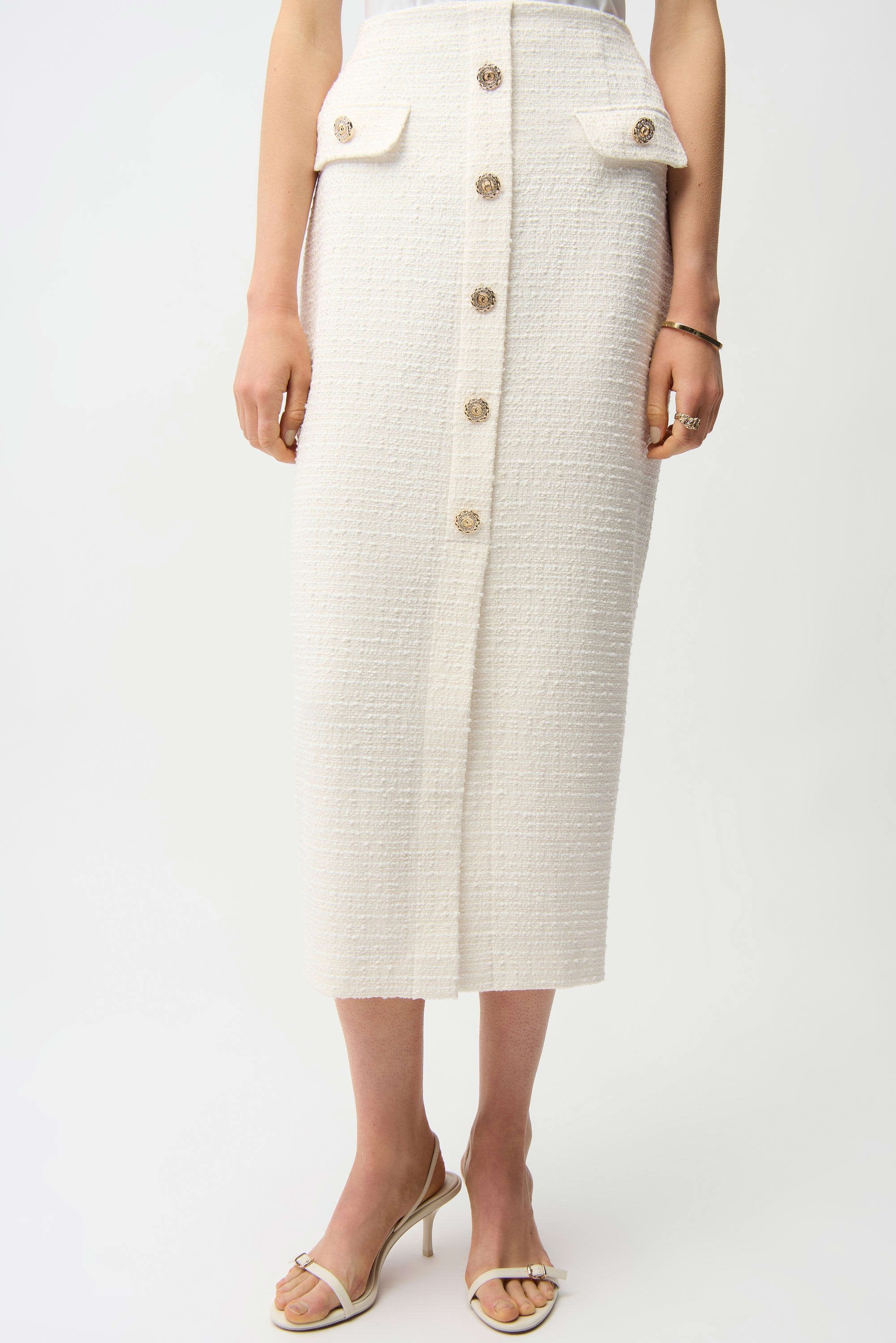 Person wearing a white button-up skirt on a white background
