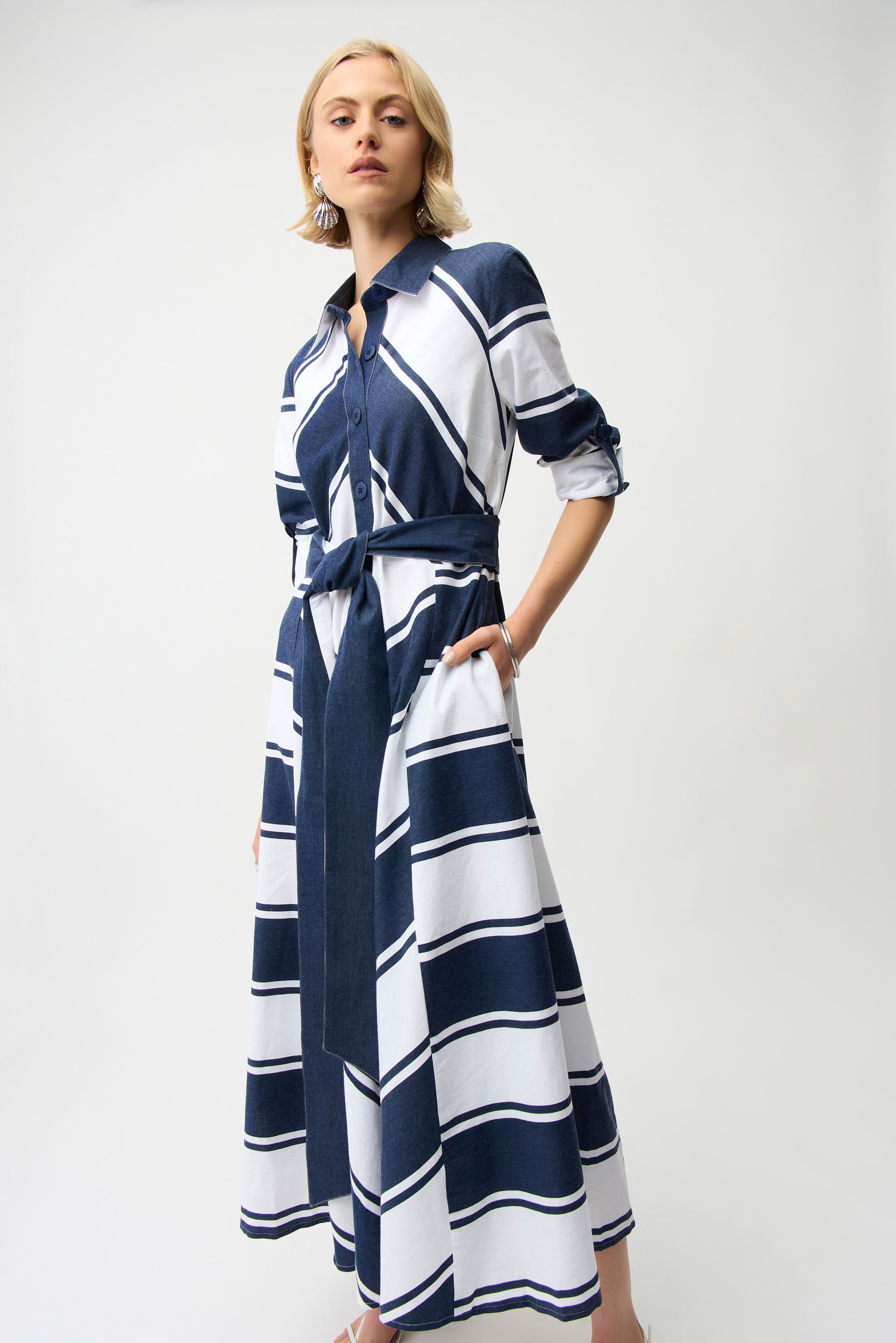 Woman wearing a blue and white striped dress on a white background