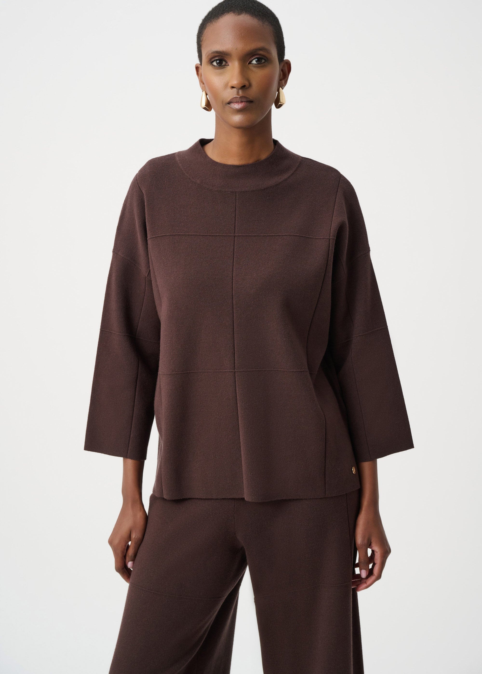 Woman wearing a brown outfit on a white background