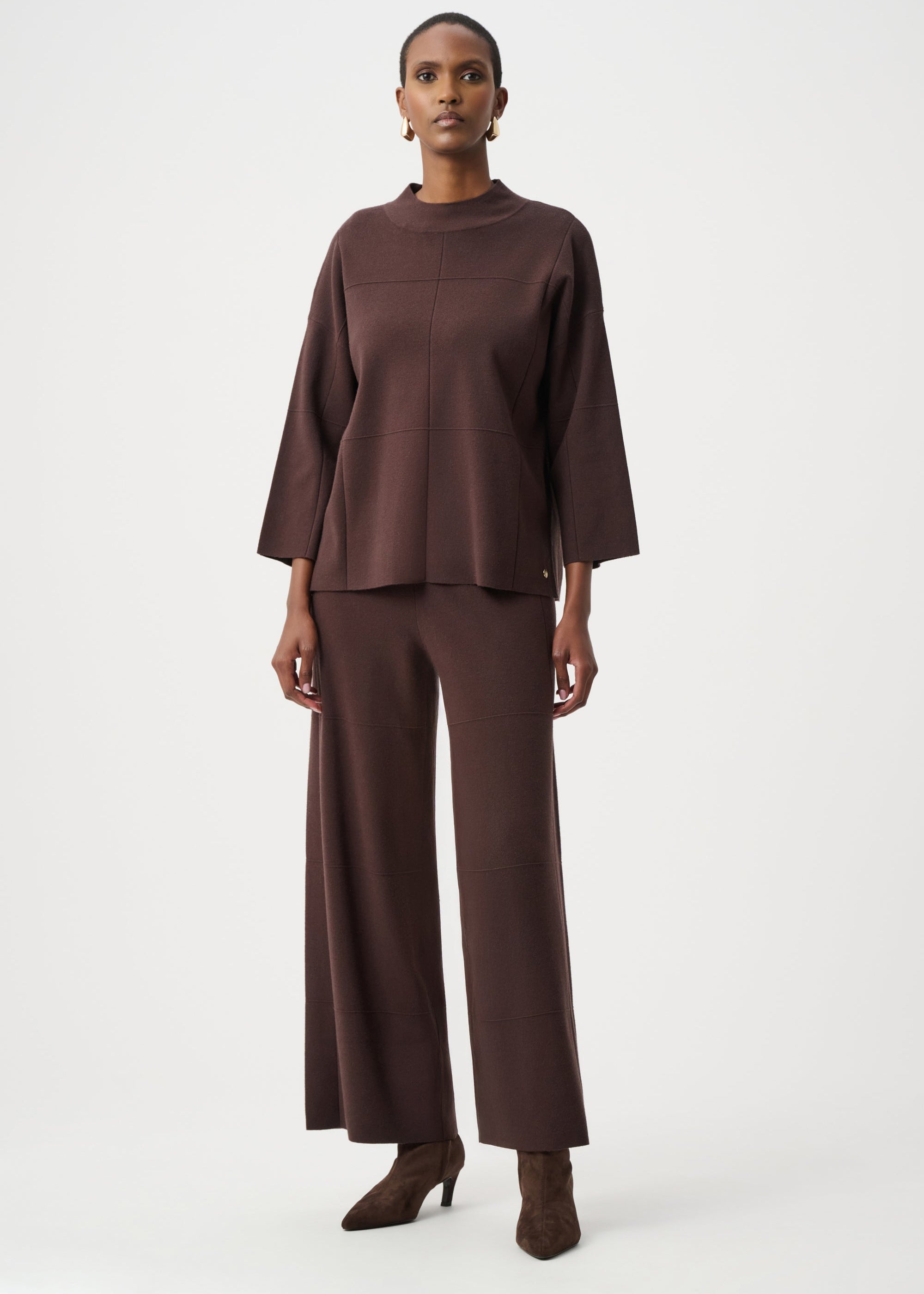 Woman wearing a brown outfit on a white background