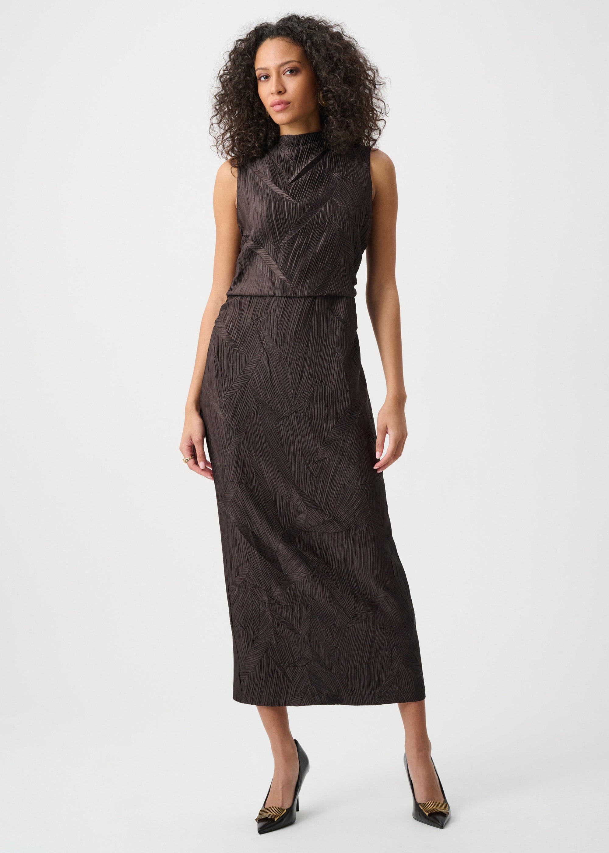 Woman wearing a dark brown dress on a white background