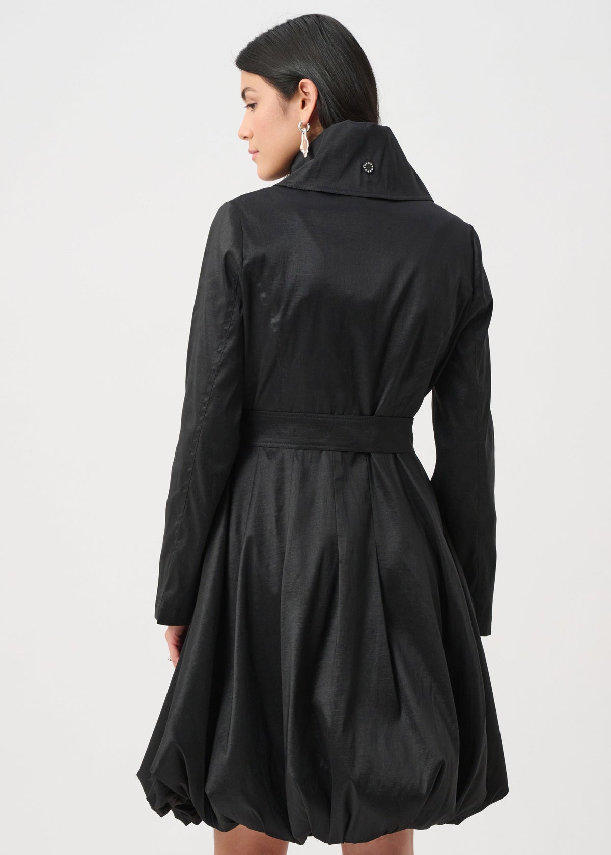 Woman wearing a black coat on a white background