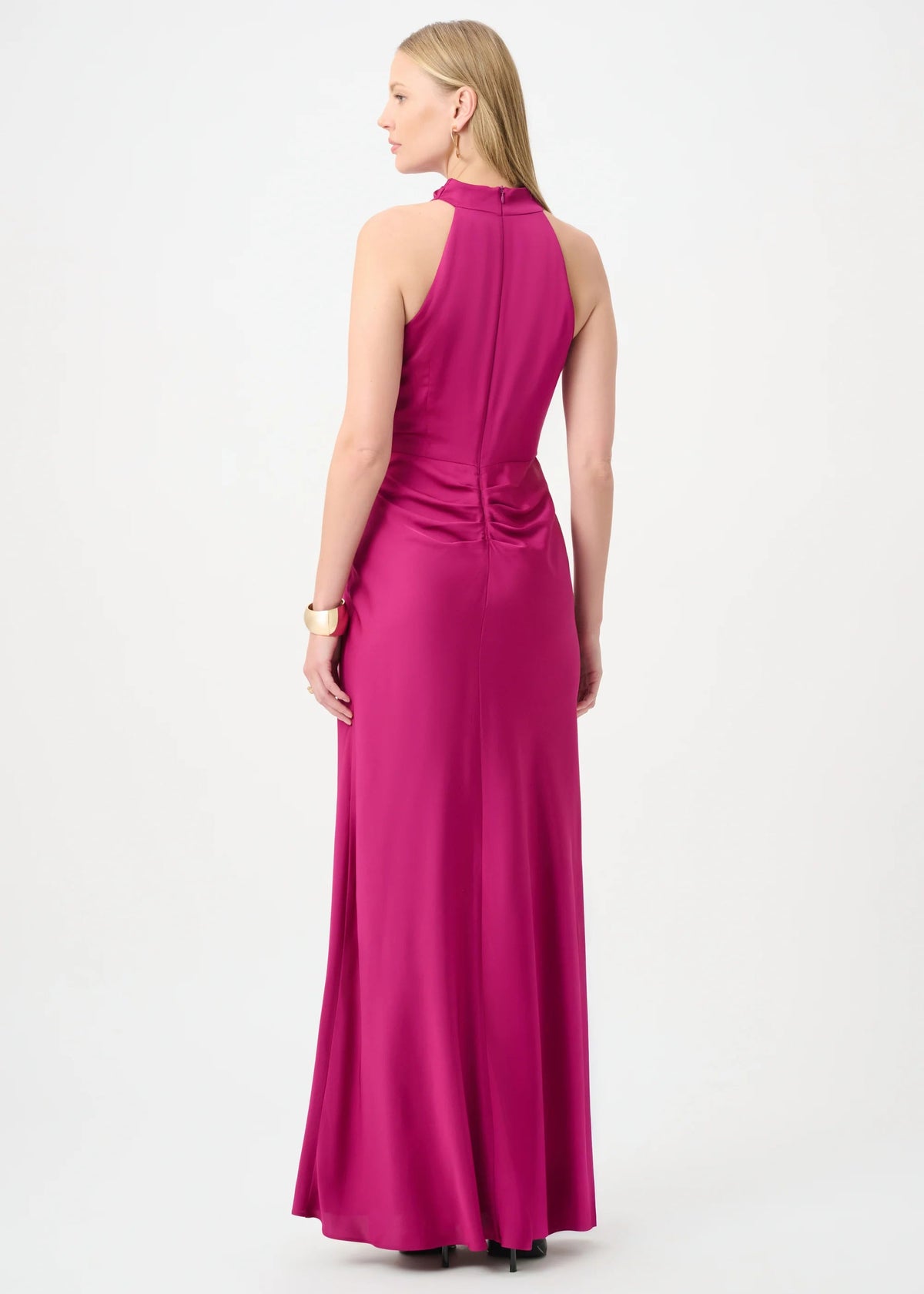 Woman wearing a pink halter neck gown on a white background