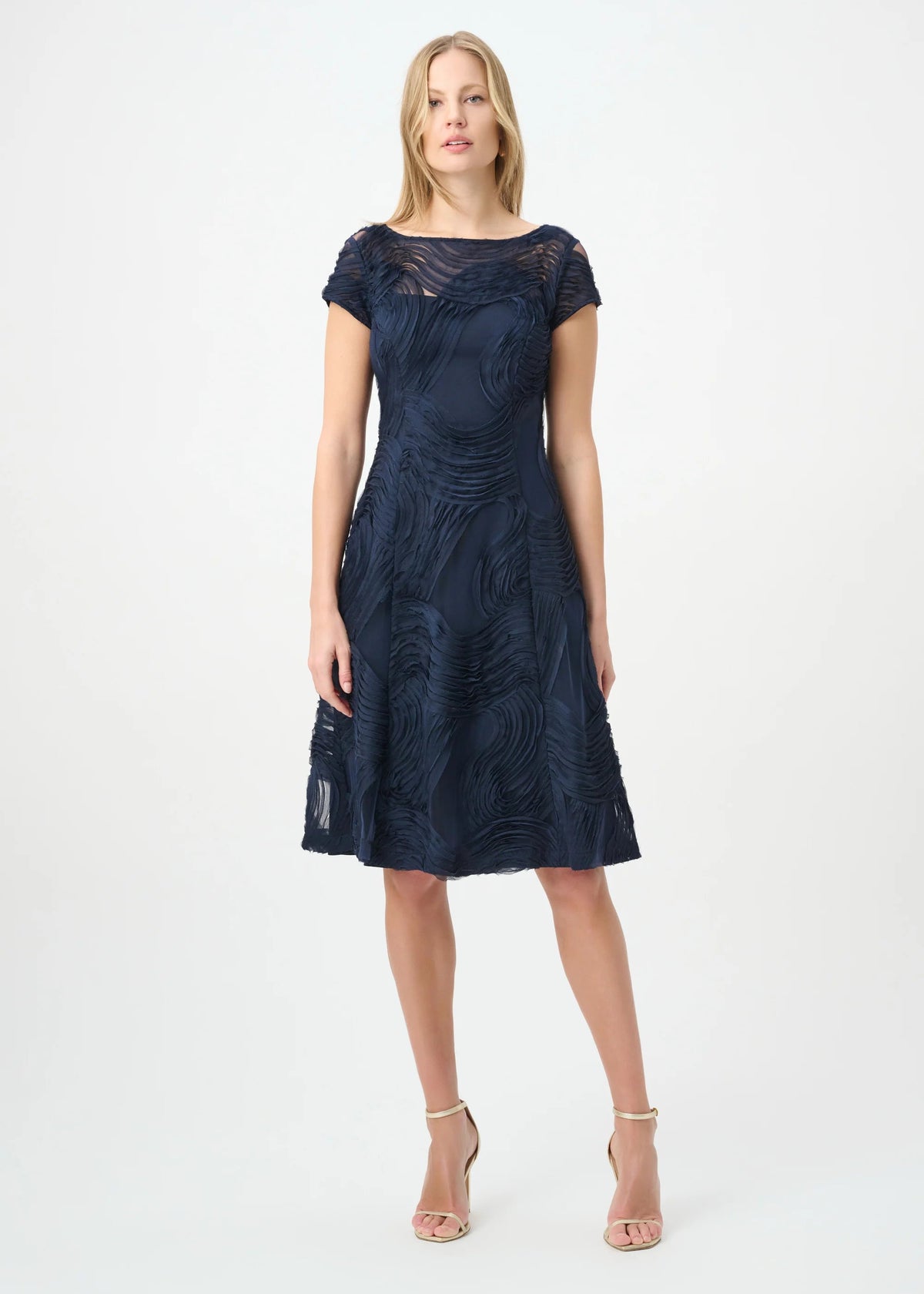 Woman wearing a navy blue dress on a white background