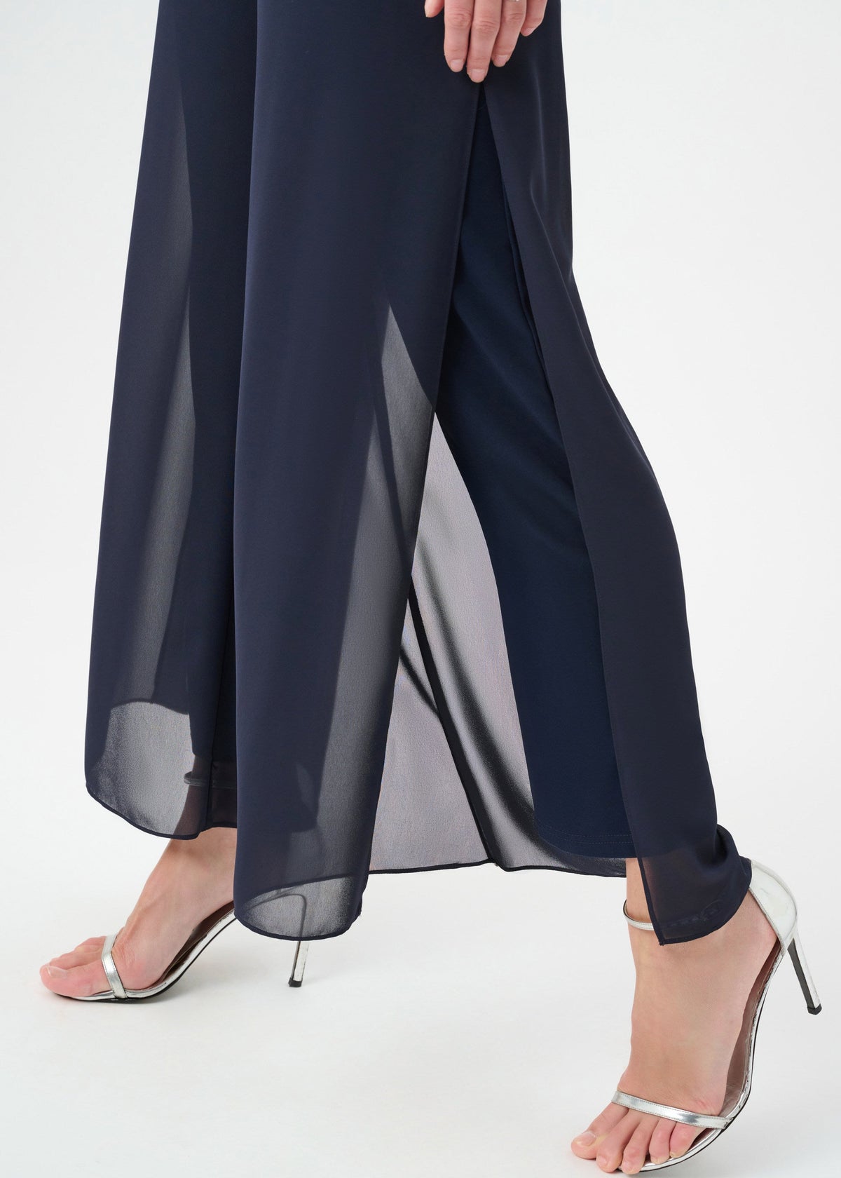 Navy blue pants worn by a person on a white background
