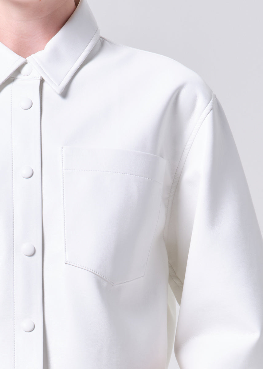 Close-up of a white shirt with buttons on a plain background
