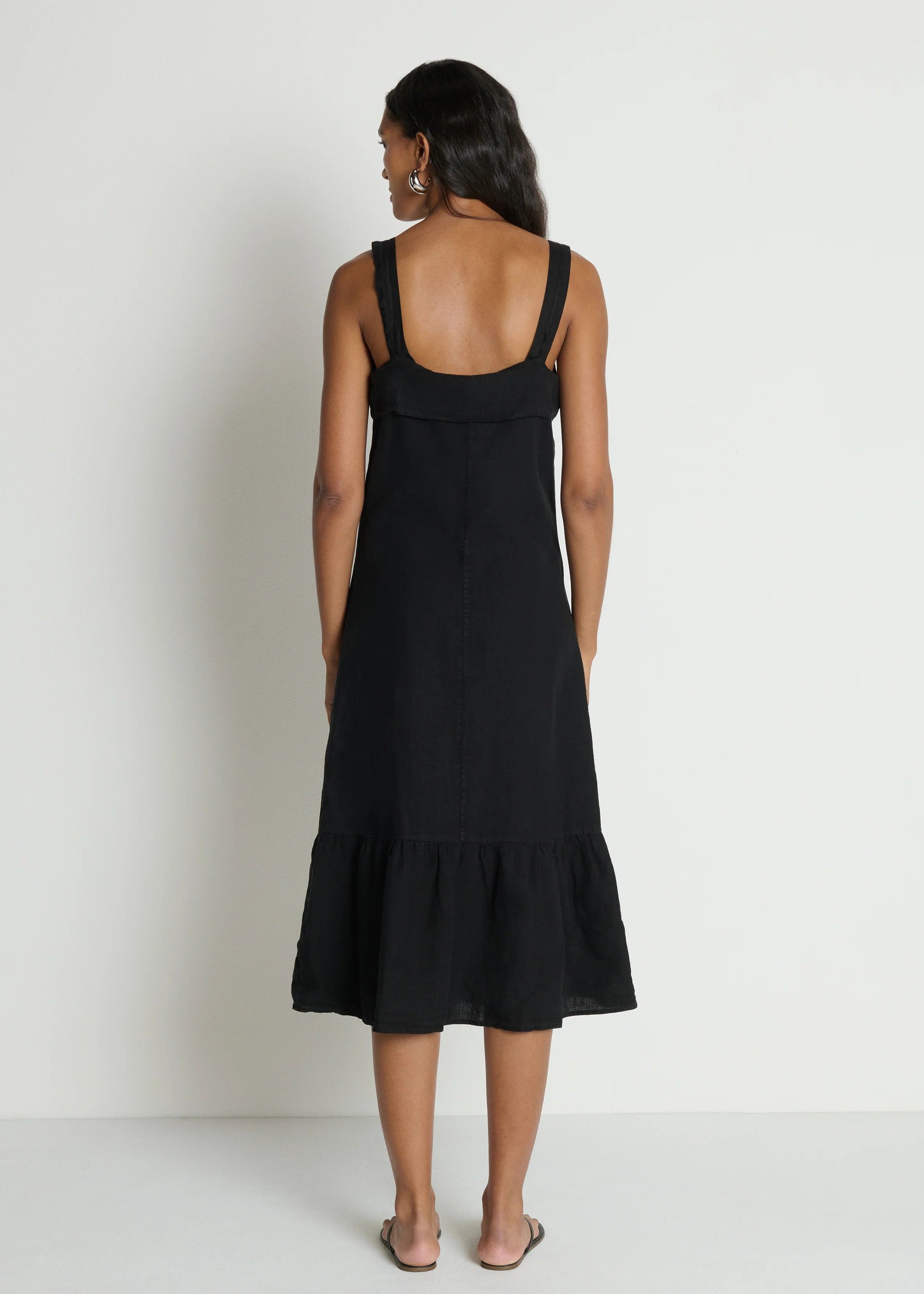 Woman wearing a black dress with a plain background