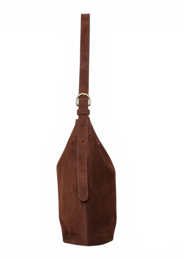 Brown leather bag with a strap on a white background