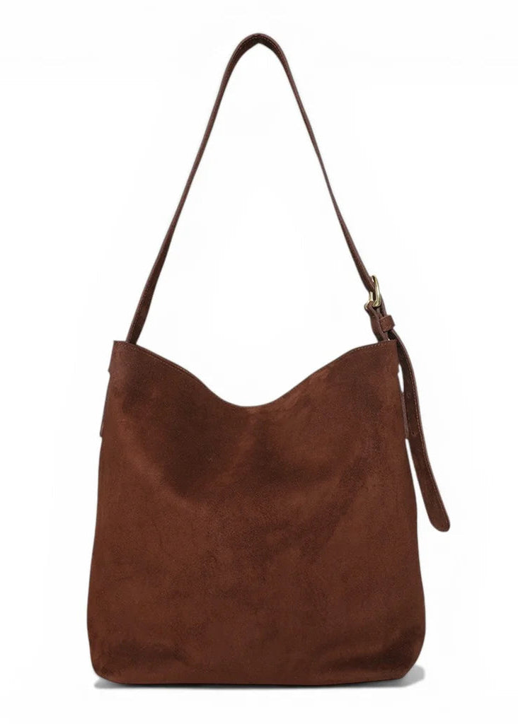 Brown suede handbag on a white background