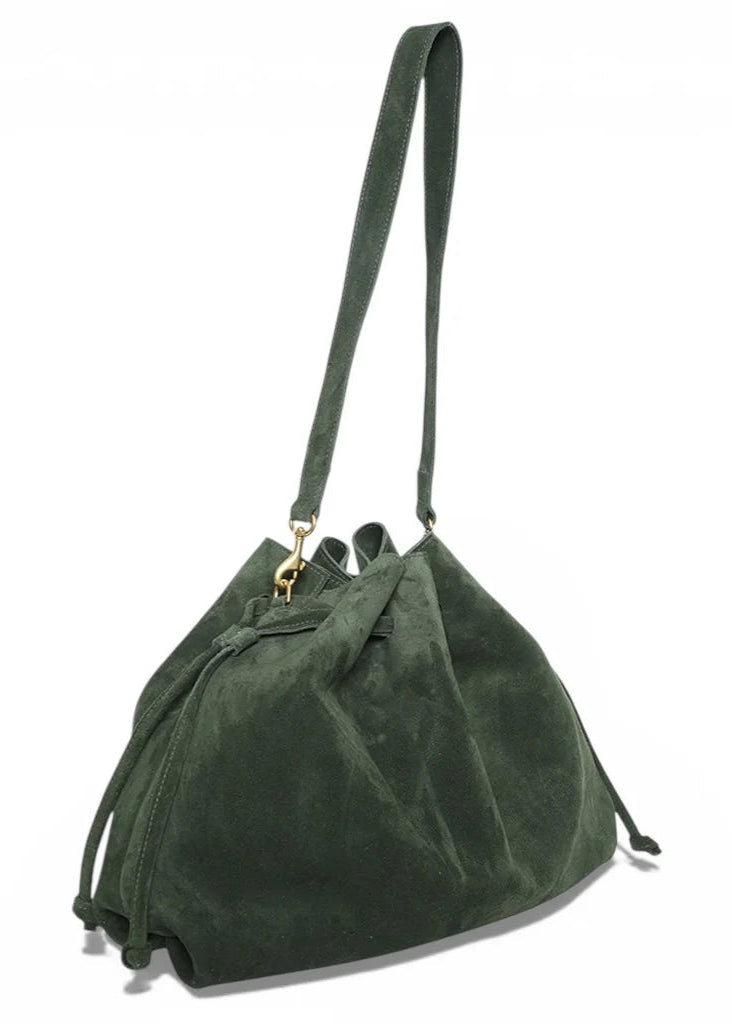 Green suede handbag with a strap on a white background