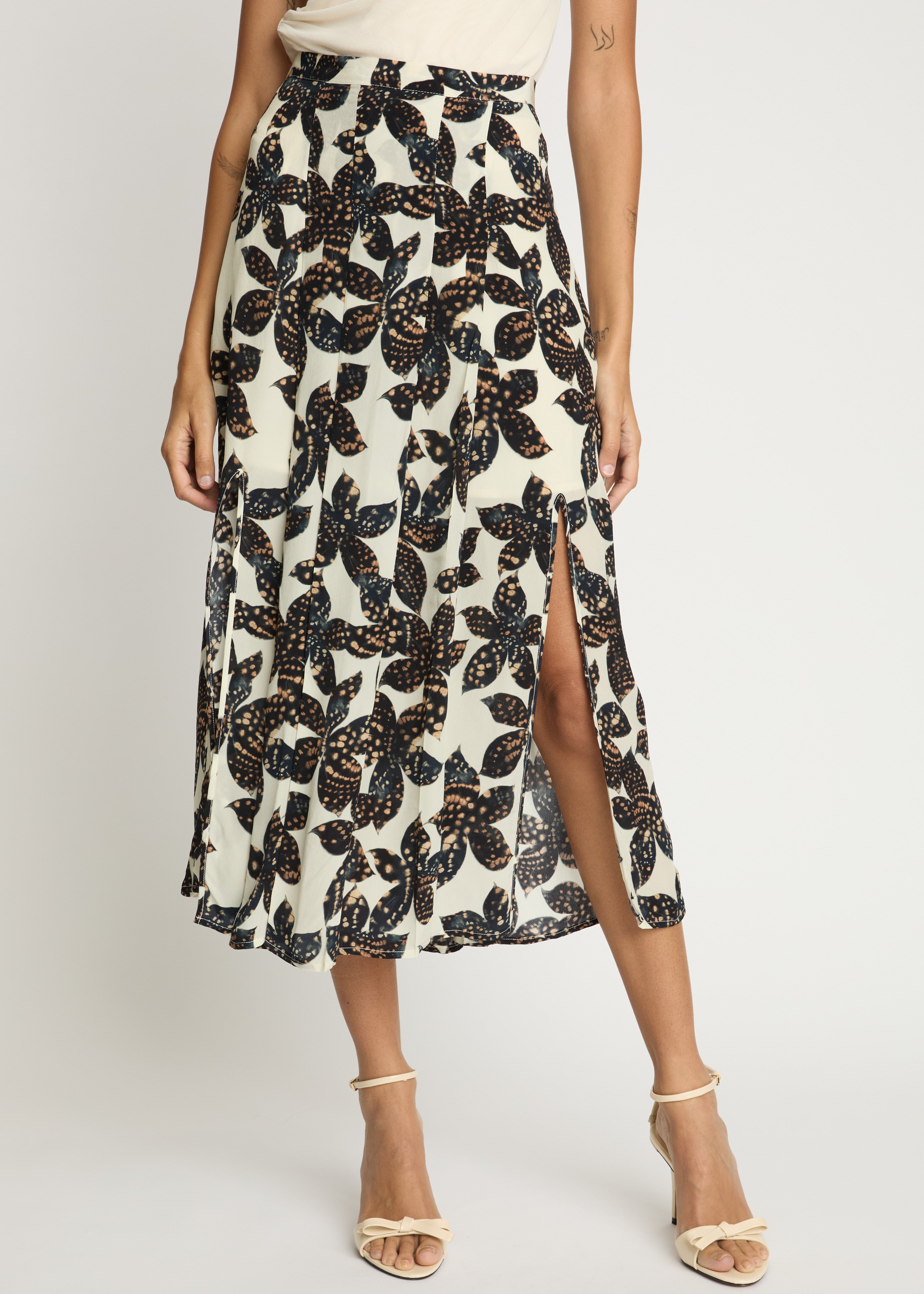 Woman wearing a floral patterned skirt with a white background