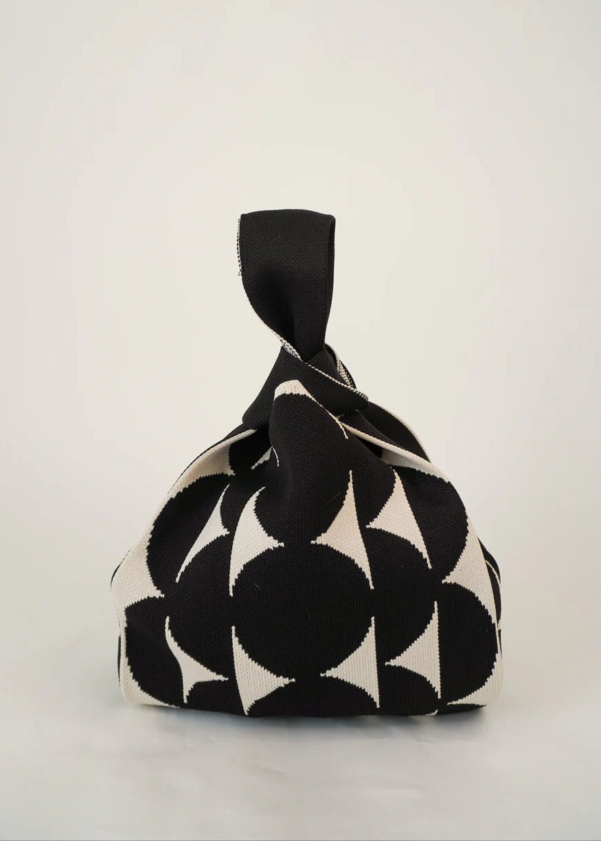 Black and white patterned fabric bag on a light gray background