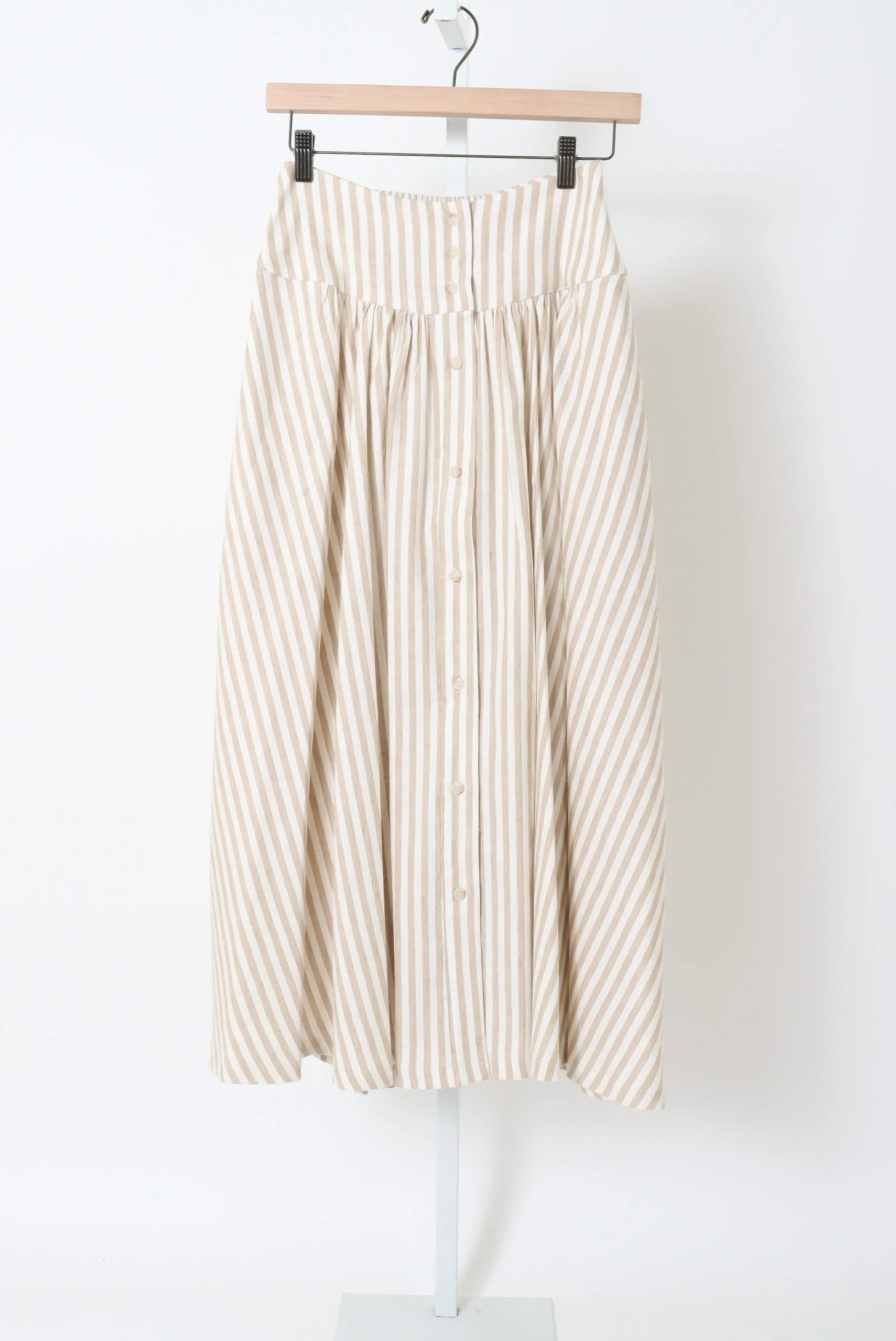 Striped skirt on a hanger against a white background