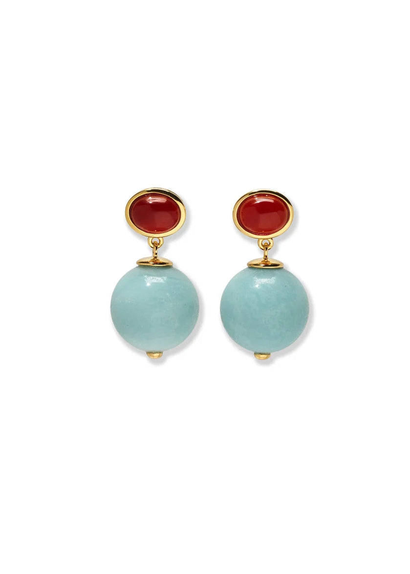 A pair of gold drop earrings featuring round light blue stone beads and oval red stone studs, displayed on a clean white background.