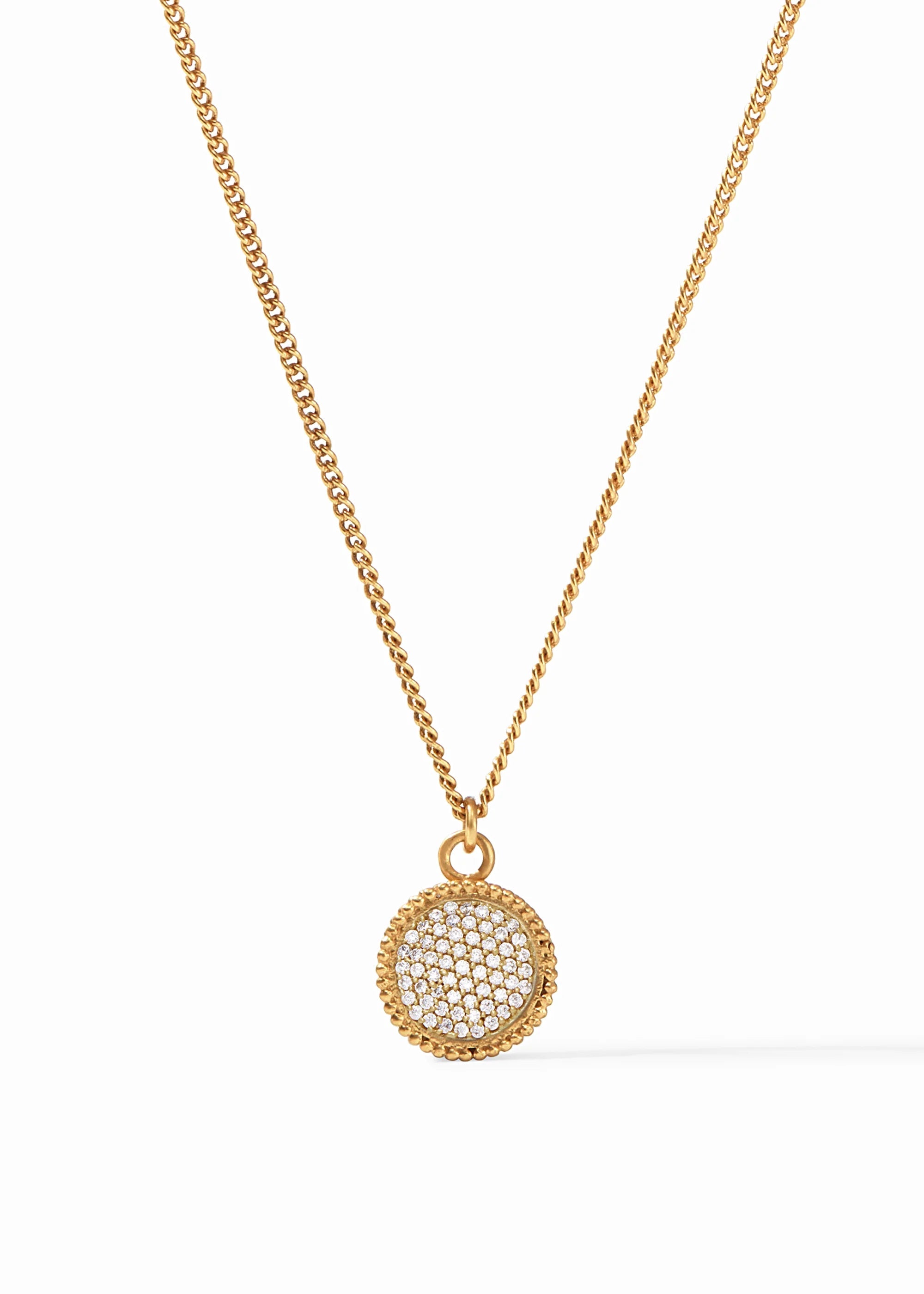 Gold necklace with a round pendant on a white background