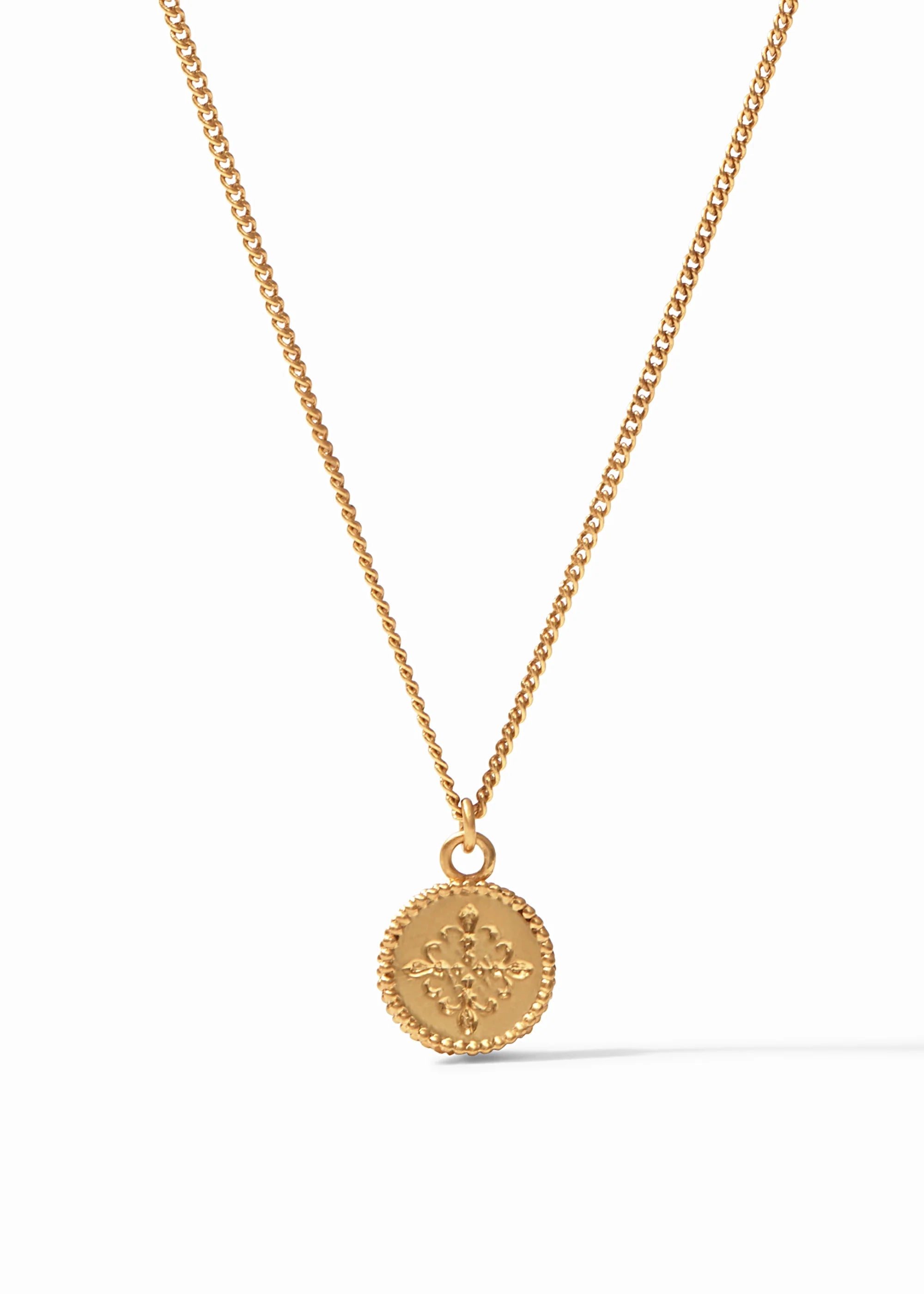 Gold necklace with a round pendant on a white background