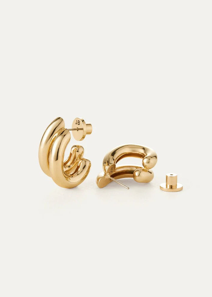 Gold hoop earrings on a light gray background