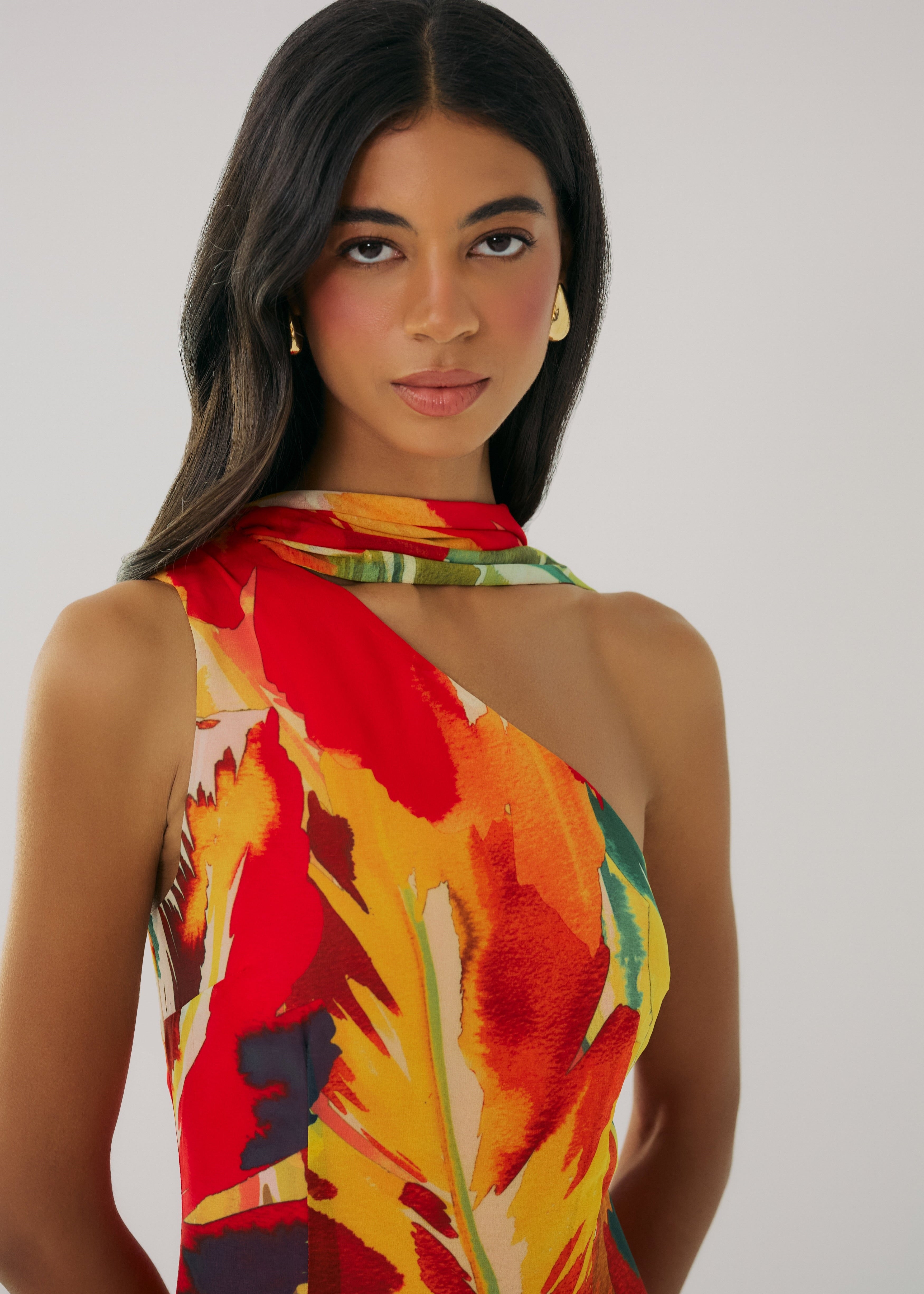 Woman wearing a colorful halter top with a white background
