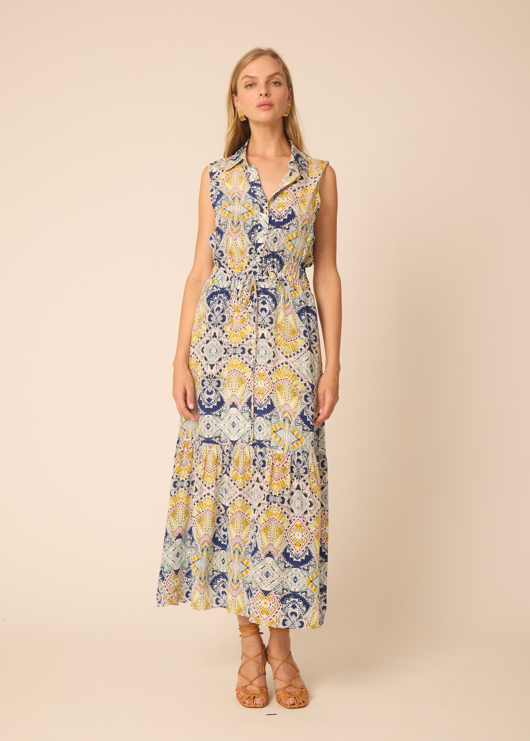 Woman wearing a sleeveless floral dress on a beige background
