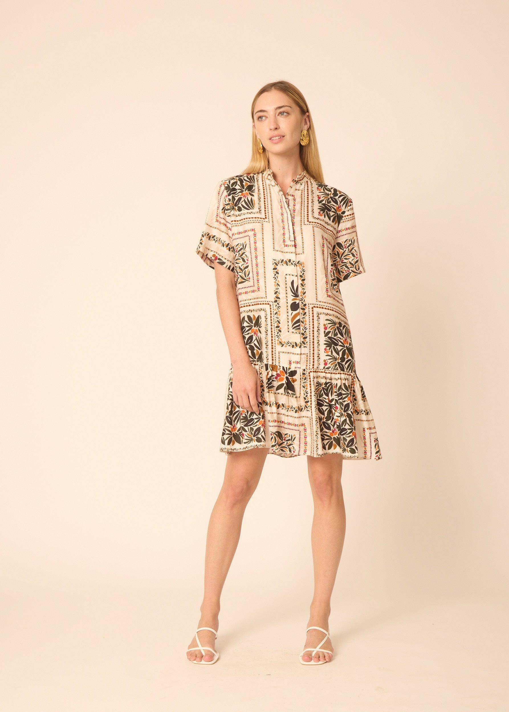 Woman wearing a patterned dress on a beige background