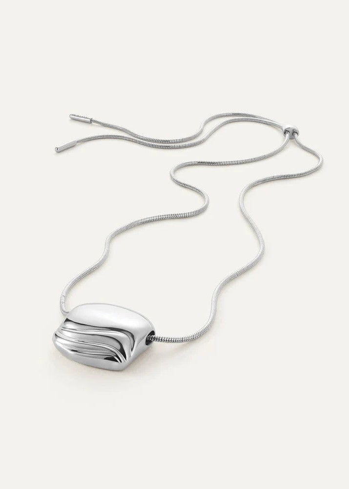 Silver necklace with a unique pendant on a white background
