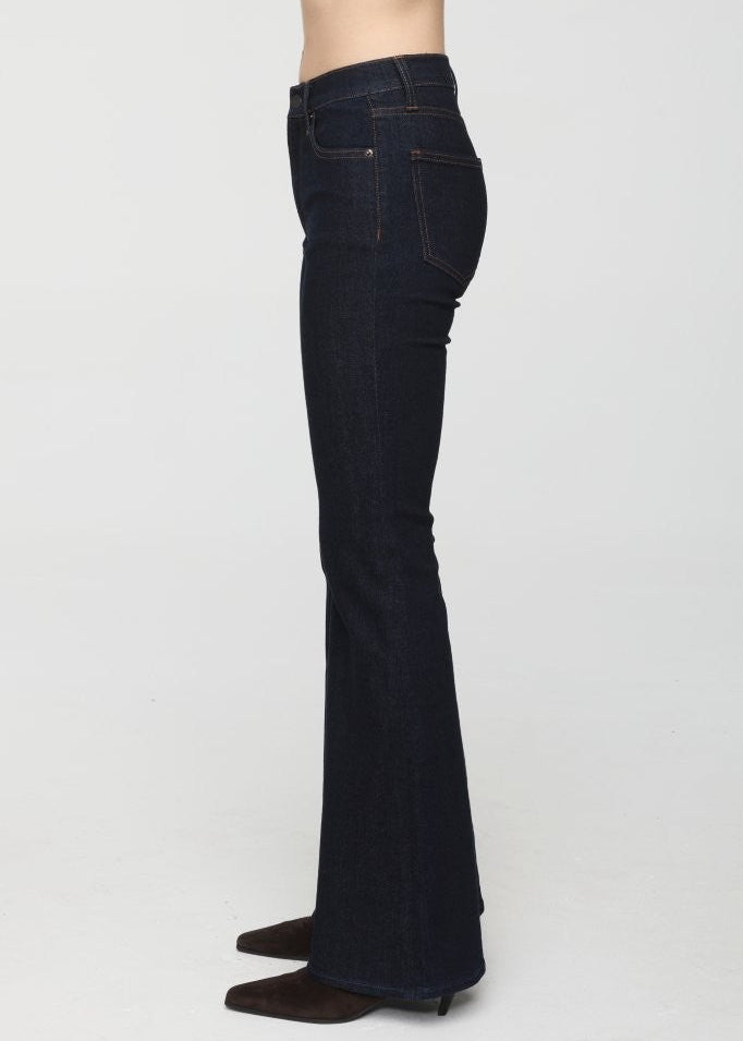Dark blue jeans worn by a person on a white background