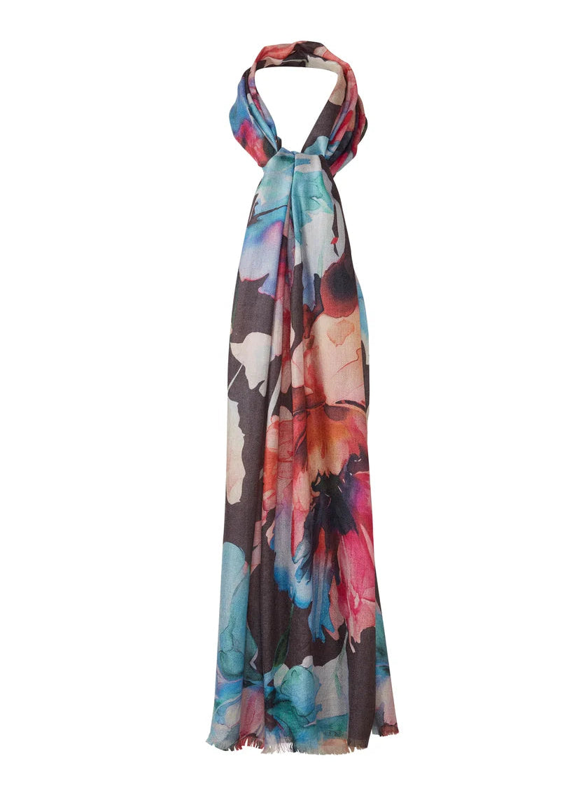 A halter-neck maxi dress featuring a vibrant, multicolored abstract floral print on a sheer, lightweight fabric, displayed against a solid white background.