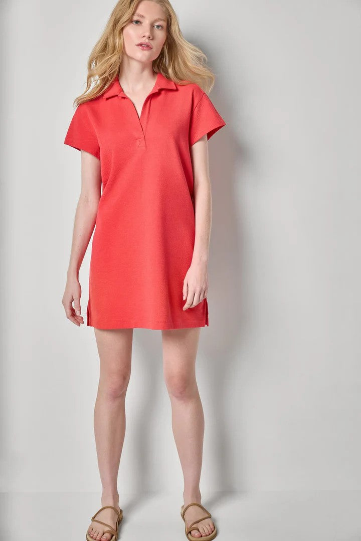 Woman in pink dress on grey background