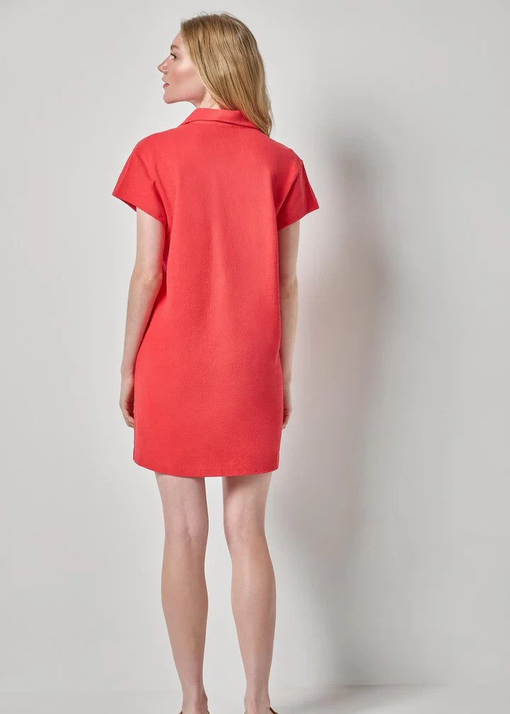 Woman in pink dress on grey background