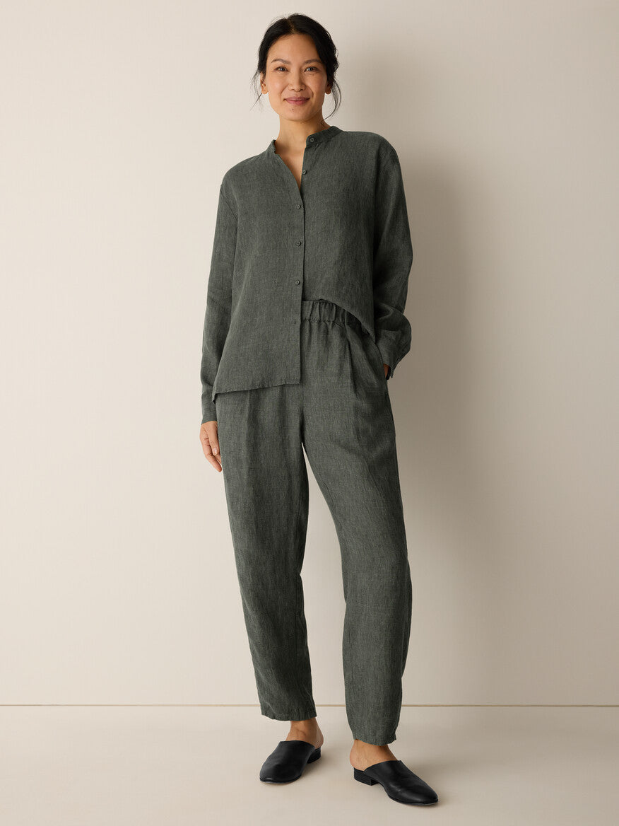 Woman wearing a green outfit against a plain background