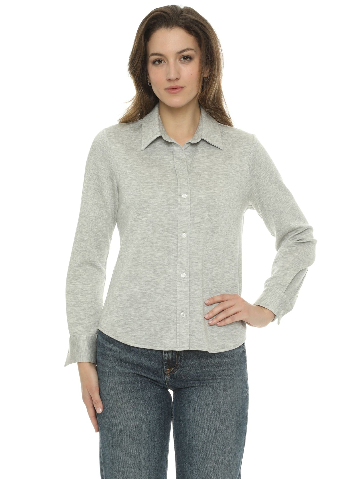 A woman modeling a light gray long-sleeve button-up knit shirt with a collar, paired with blue jeans, against a plain white background.