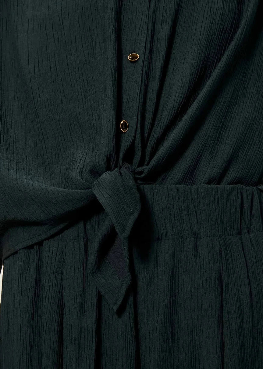 Dark green dress with a tie waist on a plain background