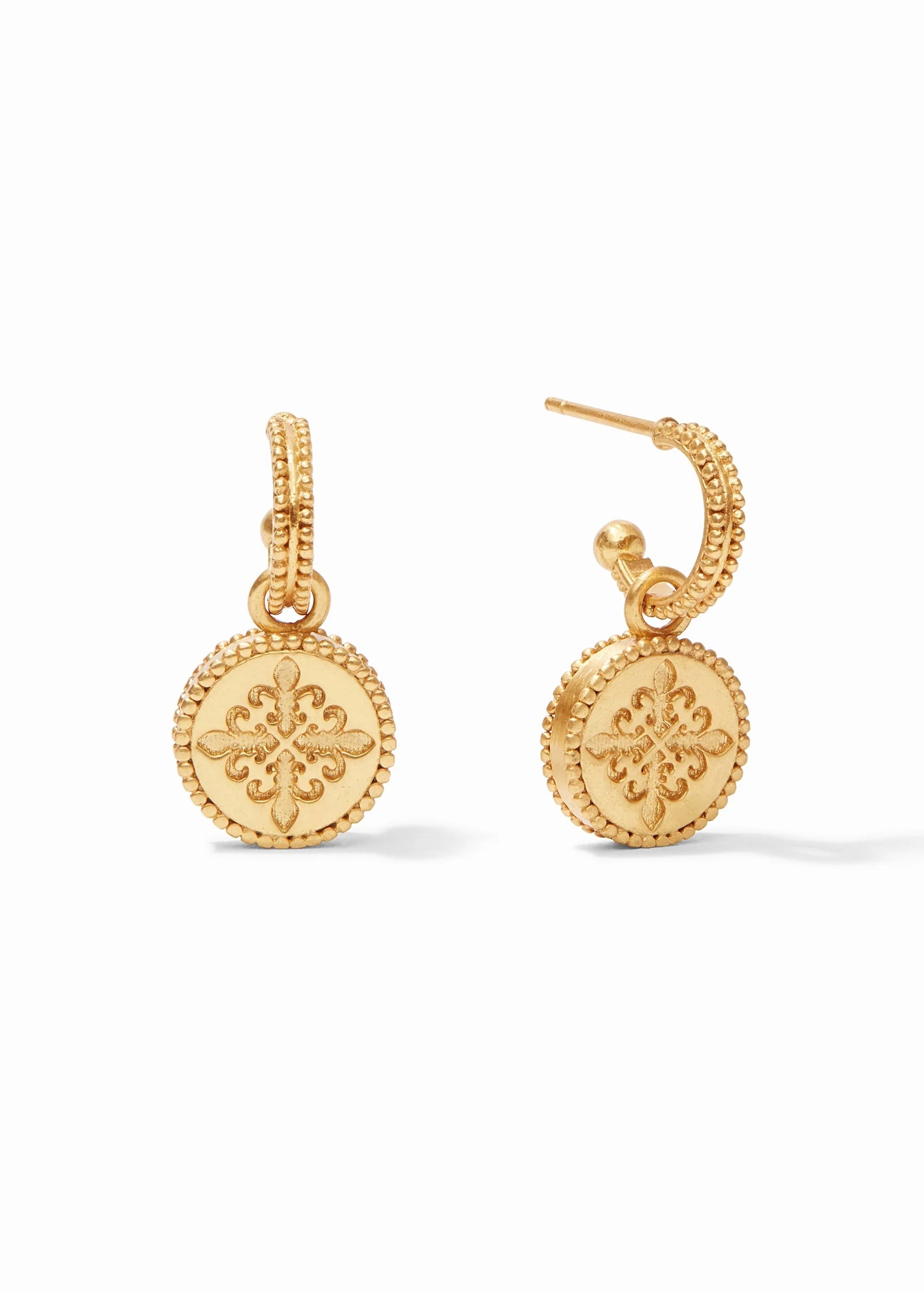 Gold earrings with intricate designs on a white background