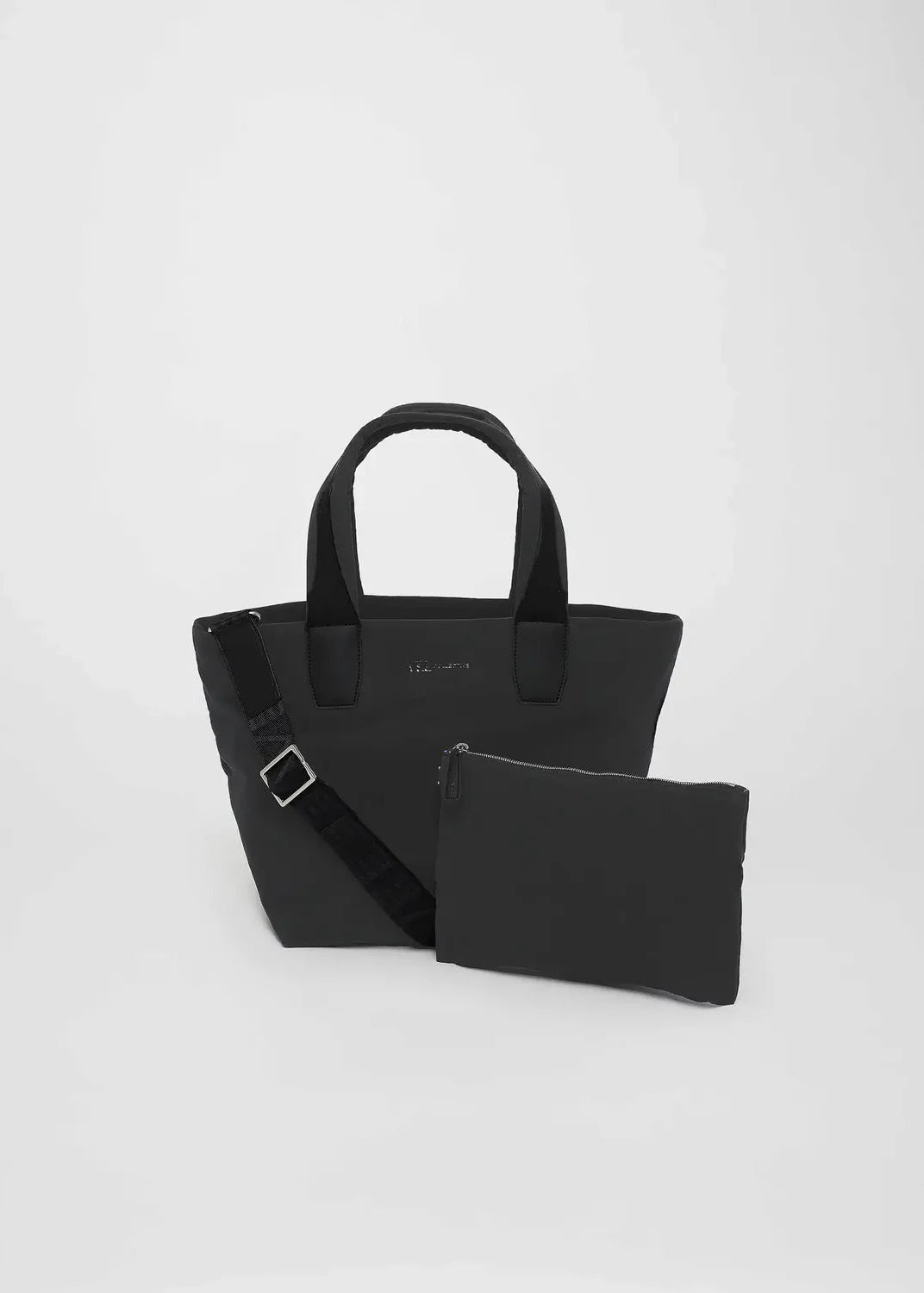 Black handbag with matching pouch on a light gray background