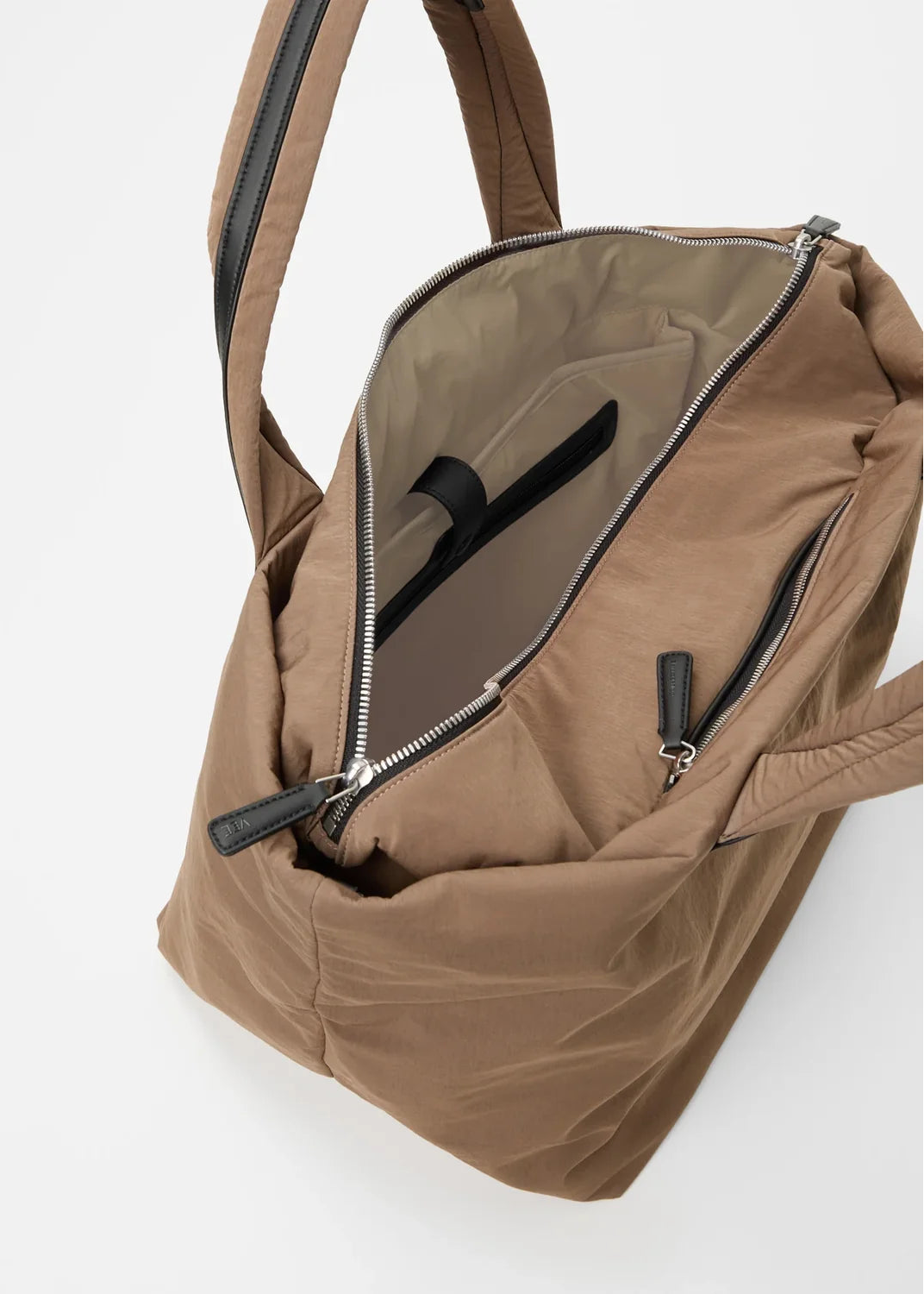 Brown backpack with open front pocket on a white background