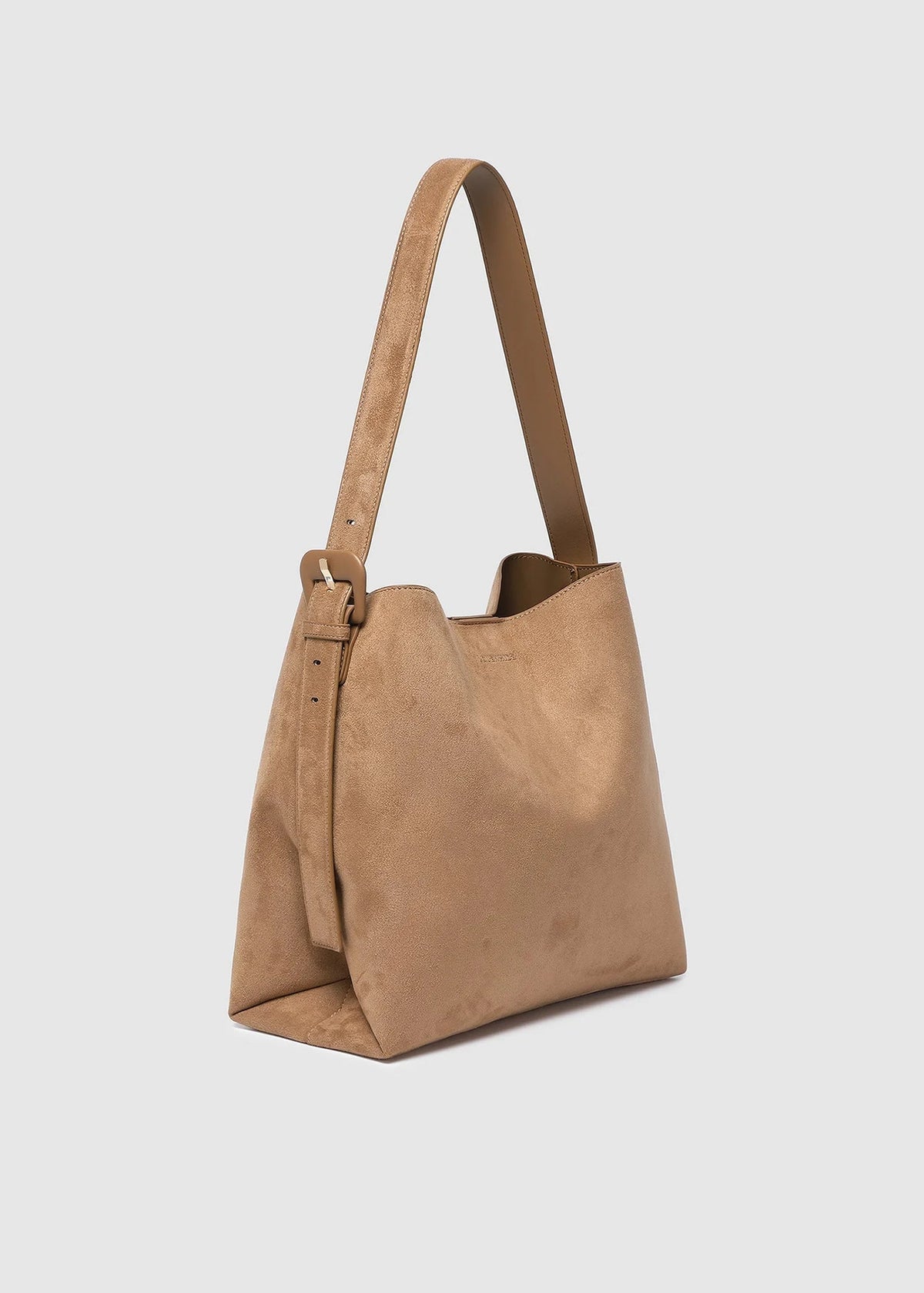 Brown suede handbag on a light gray background