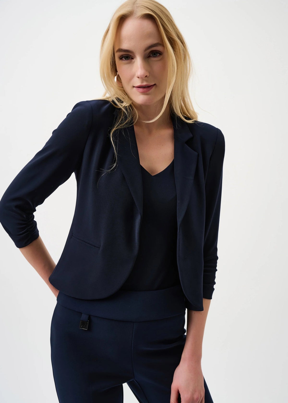 Woman wearing a navy blue suit on a white background