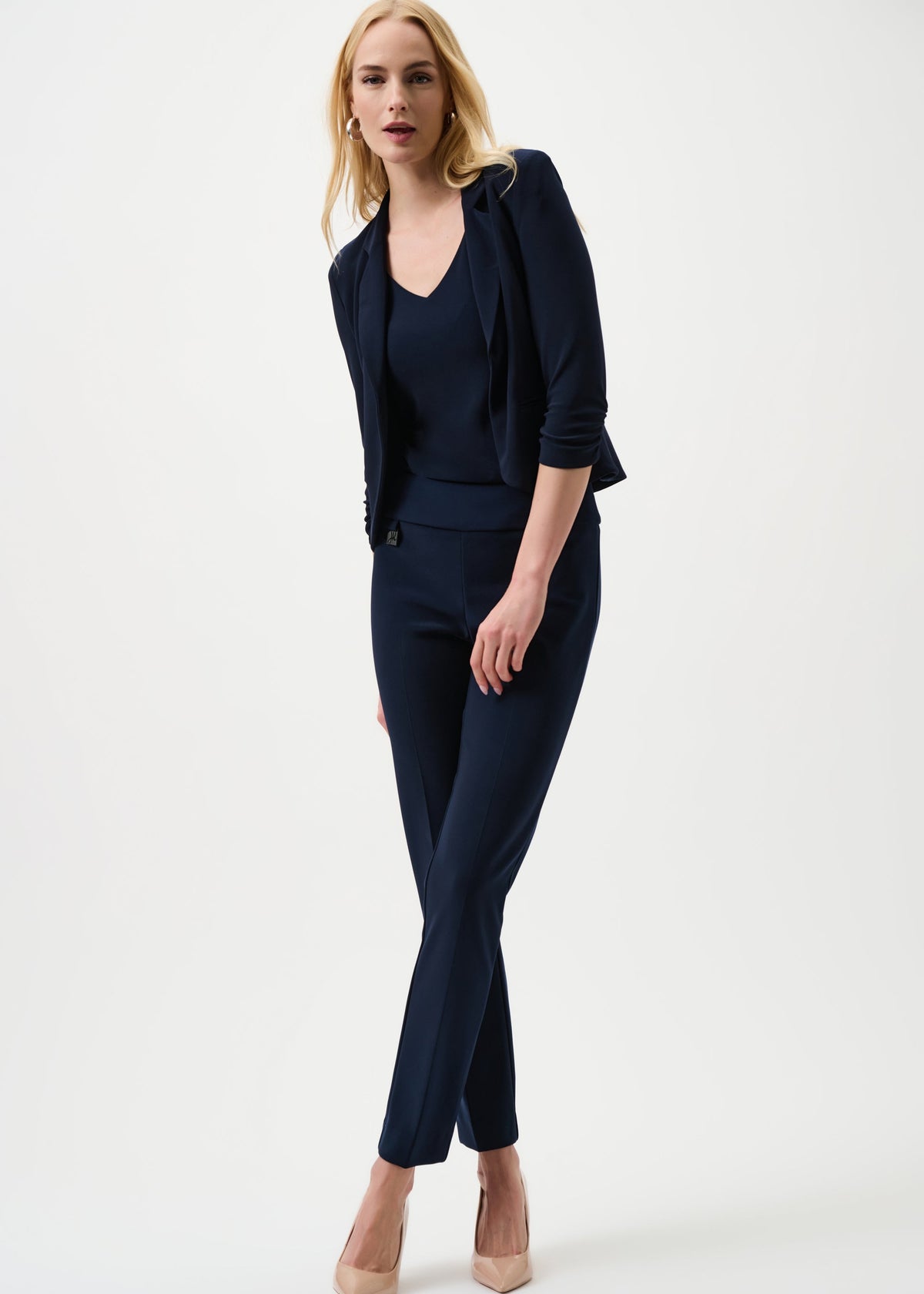 Woman wearing a navy blue suit on a white background