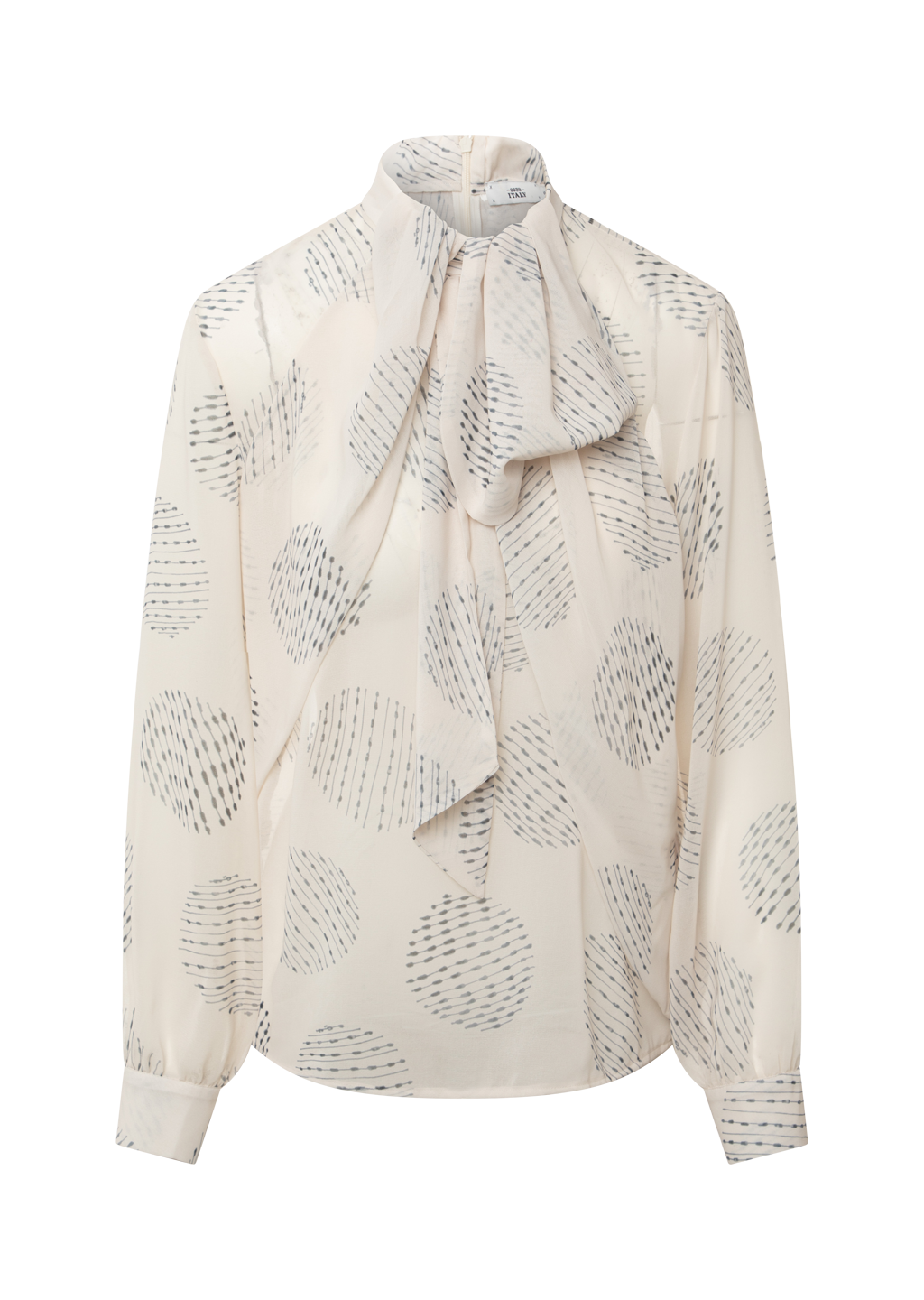 A cream-colored long-sleeve blouse with a high neck, a large front bow tie, and an all-over abstract dotted circle pattern in gray, shown against a plain white background.