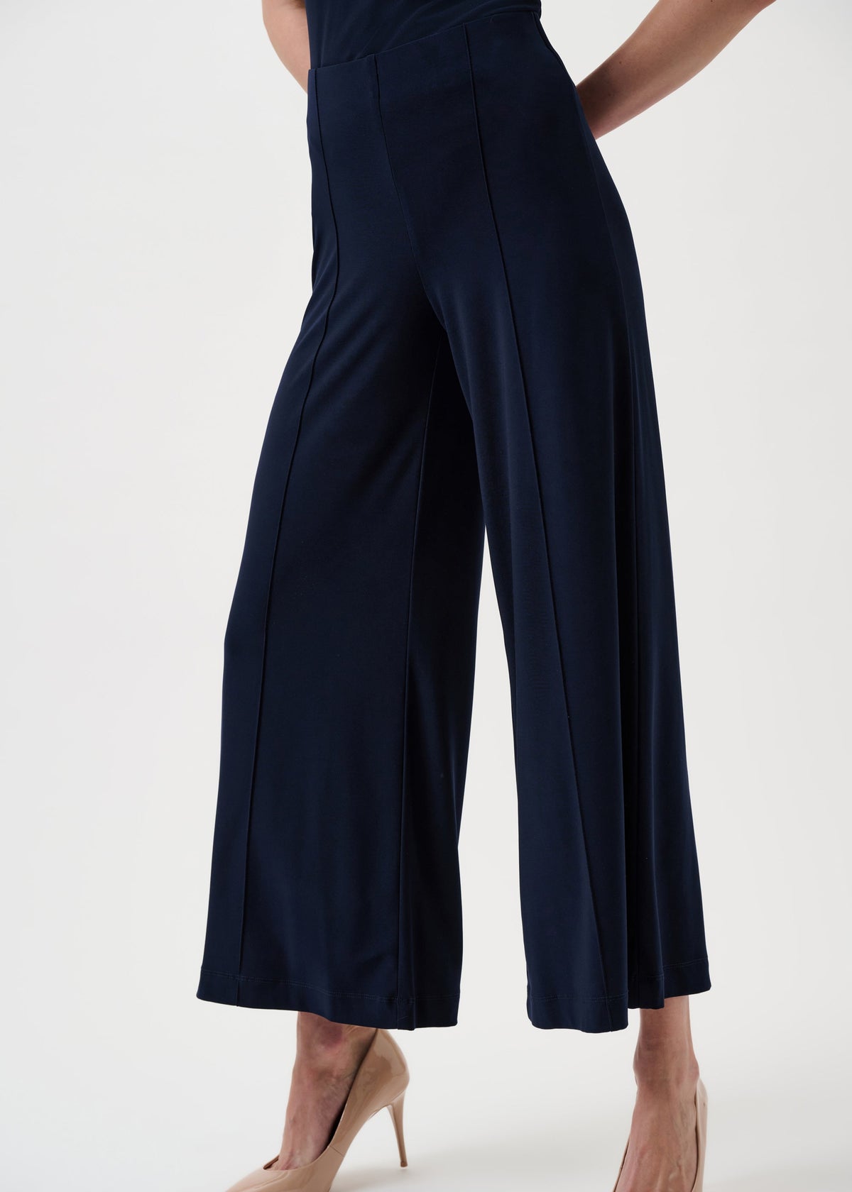 Navy blue wide-leg pants worn by a person on a white background
