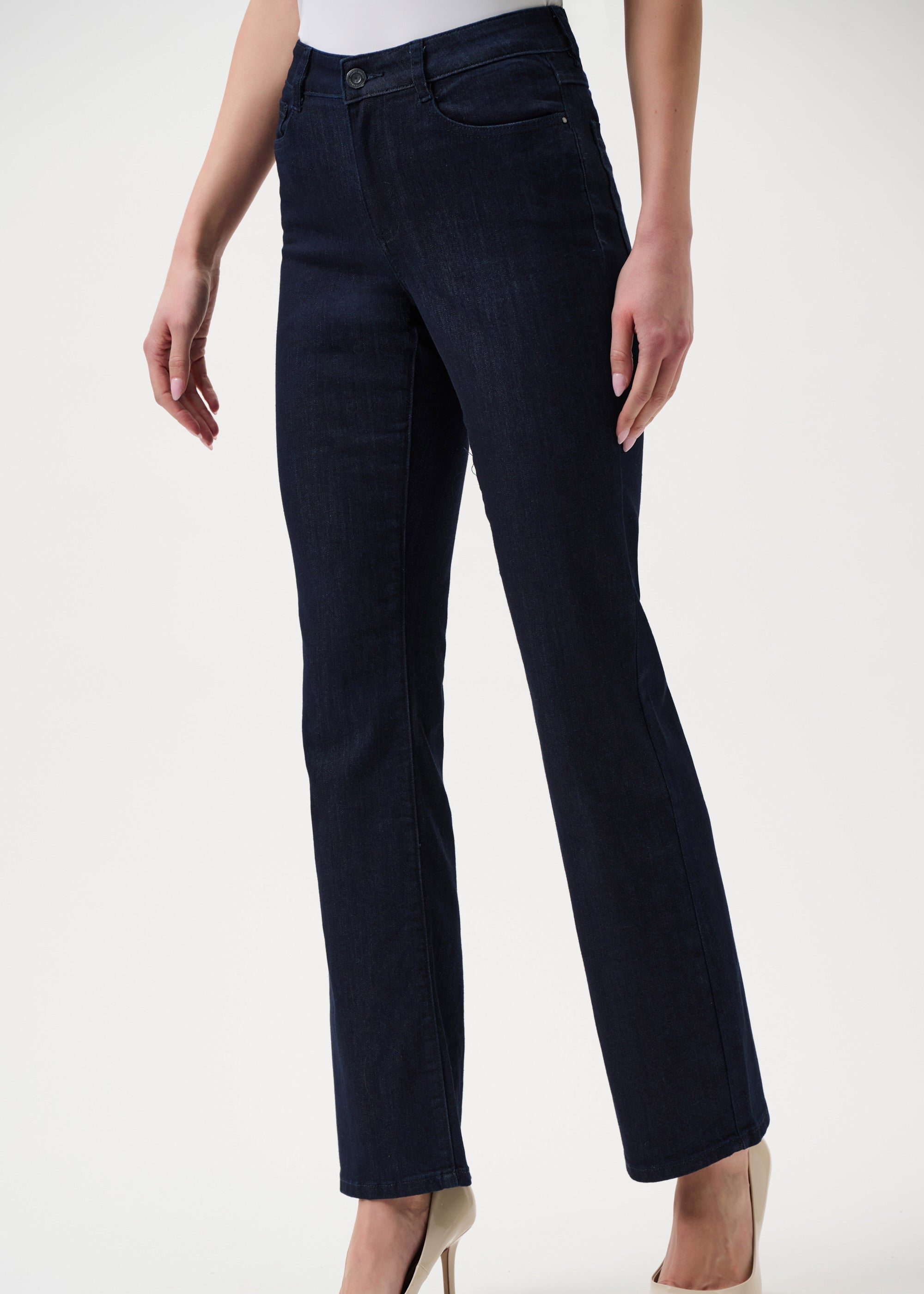 Navy blue jeans worn by a person on a white background
