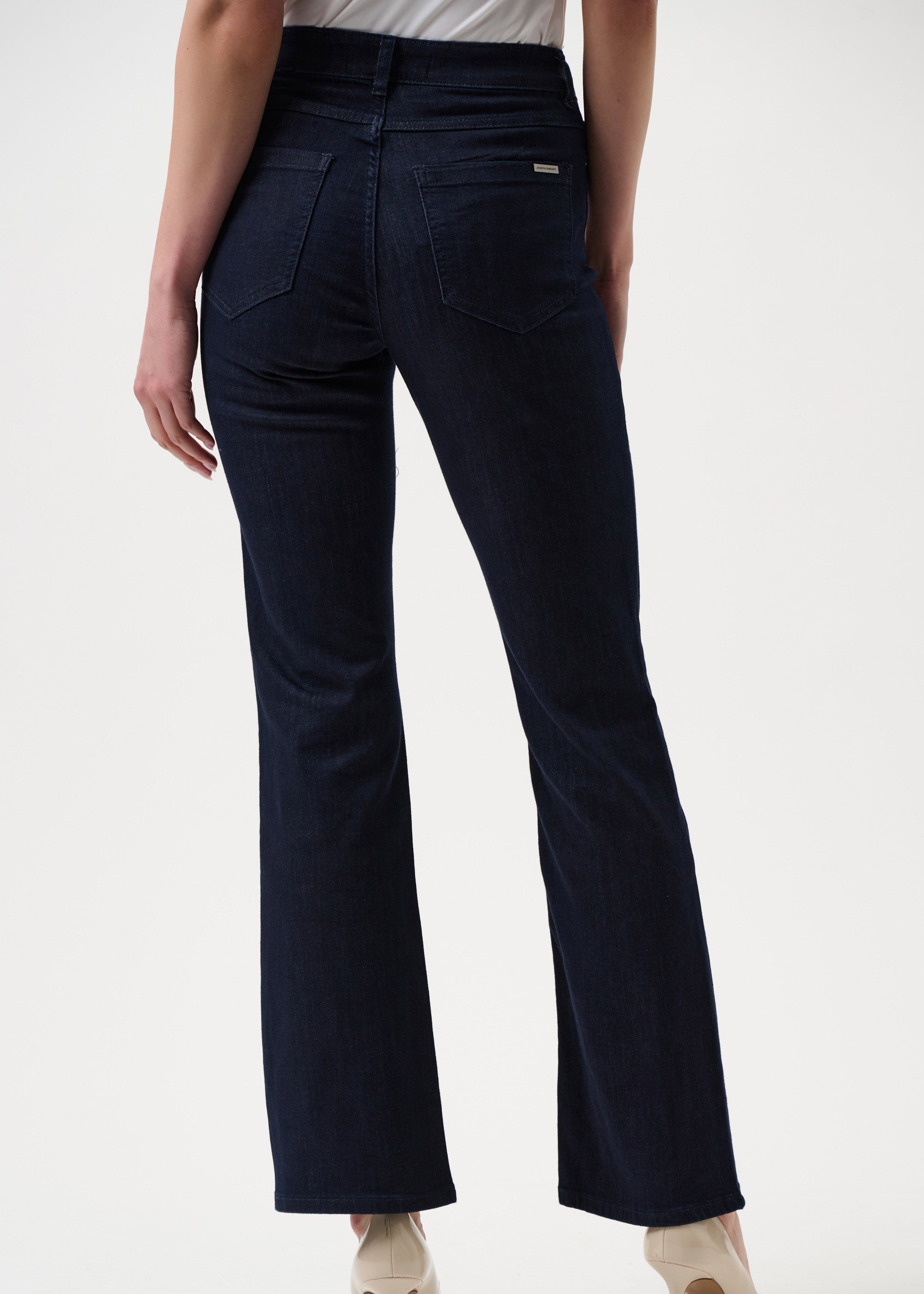 Navy blue pants worn by a person on a white background
