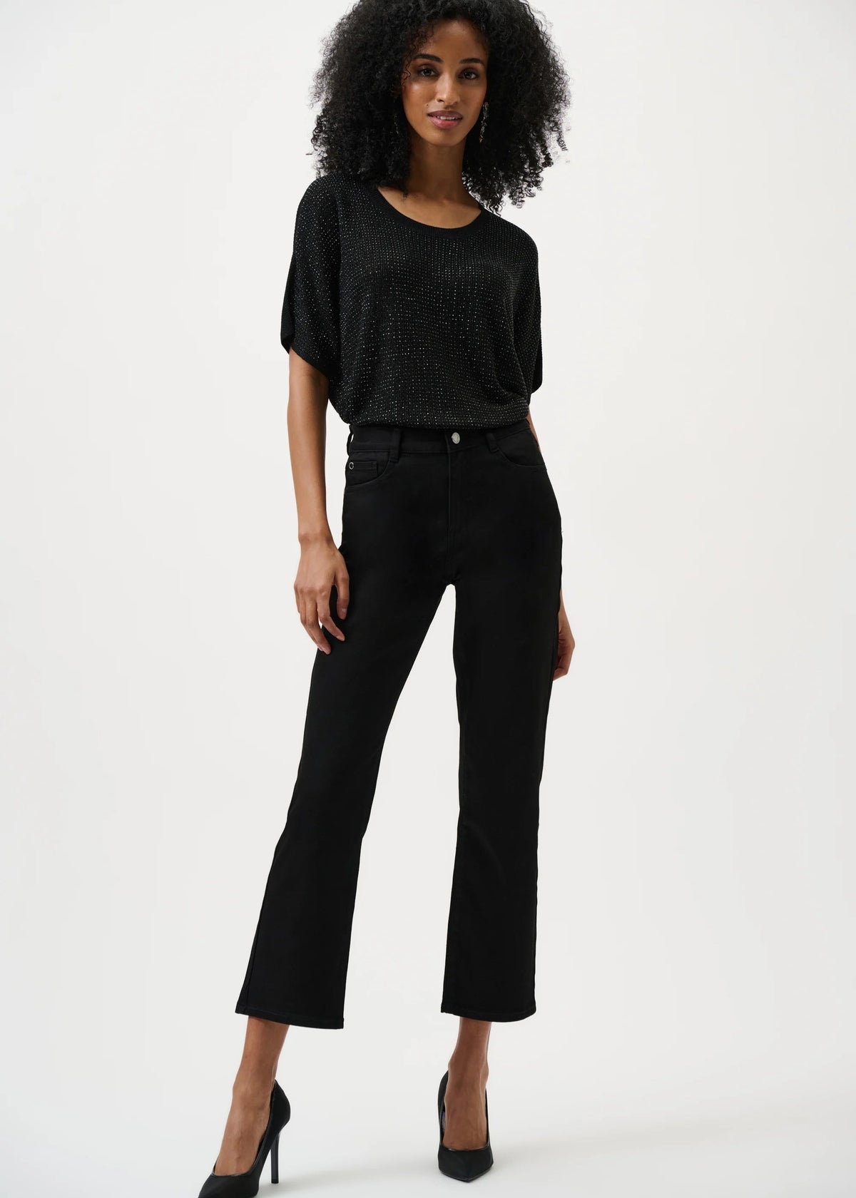 Woman wearing a black outfit on a white background