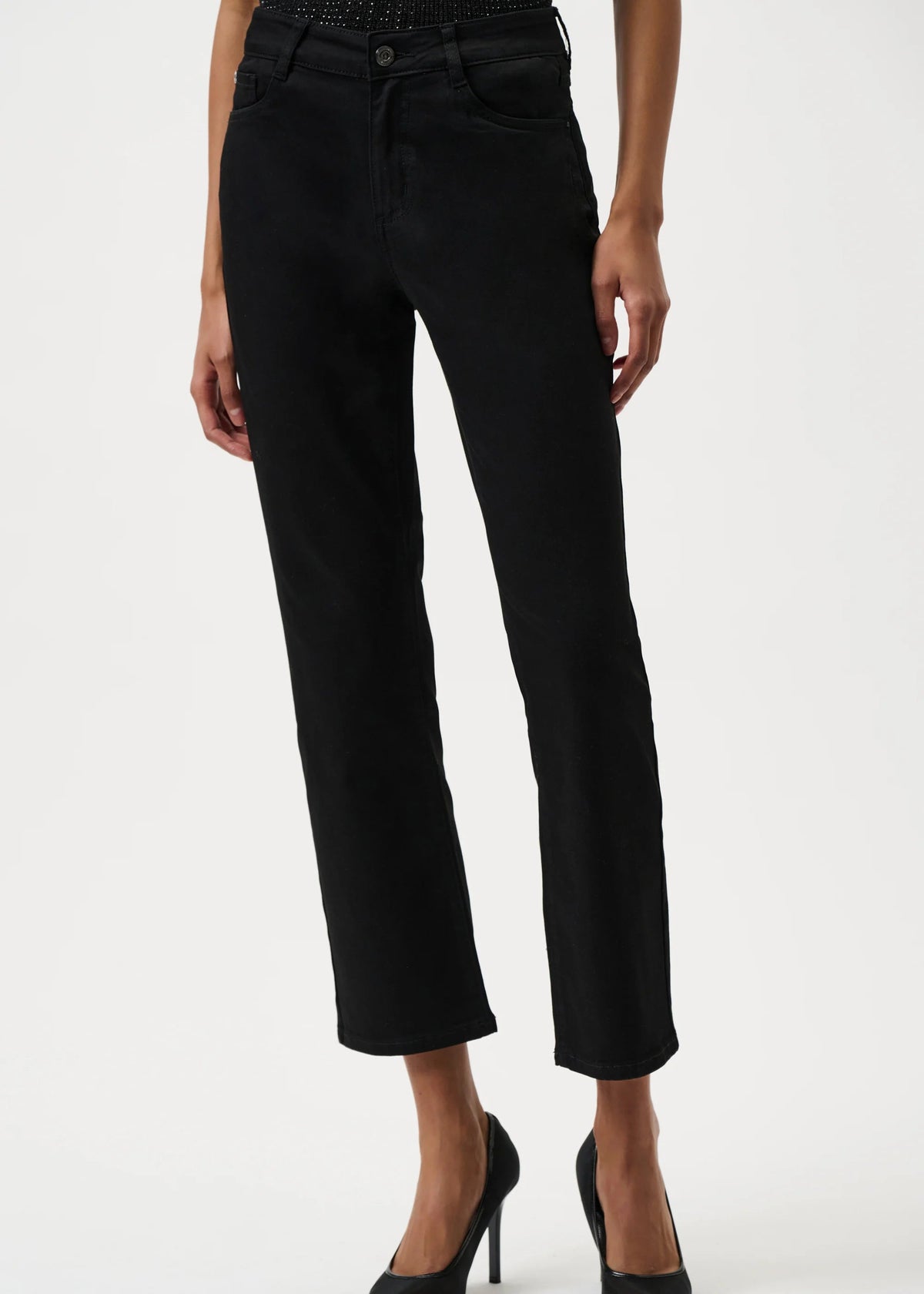 Black pants worn by a person on a white background