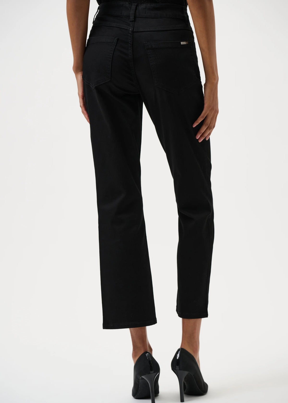 Person wearing black pants on a white background