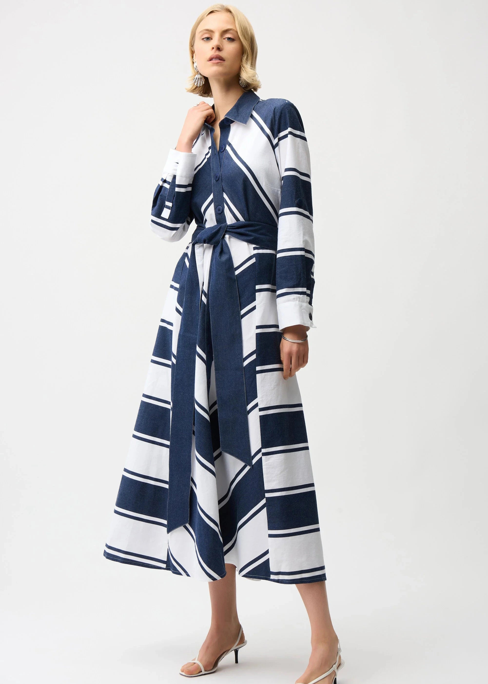 Woman wearing a blue and white striped dress on a white background